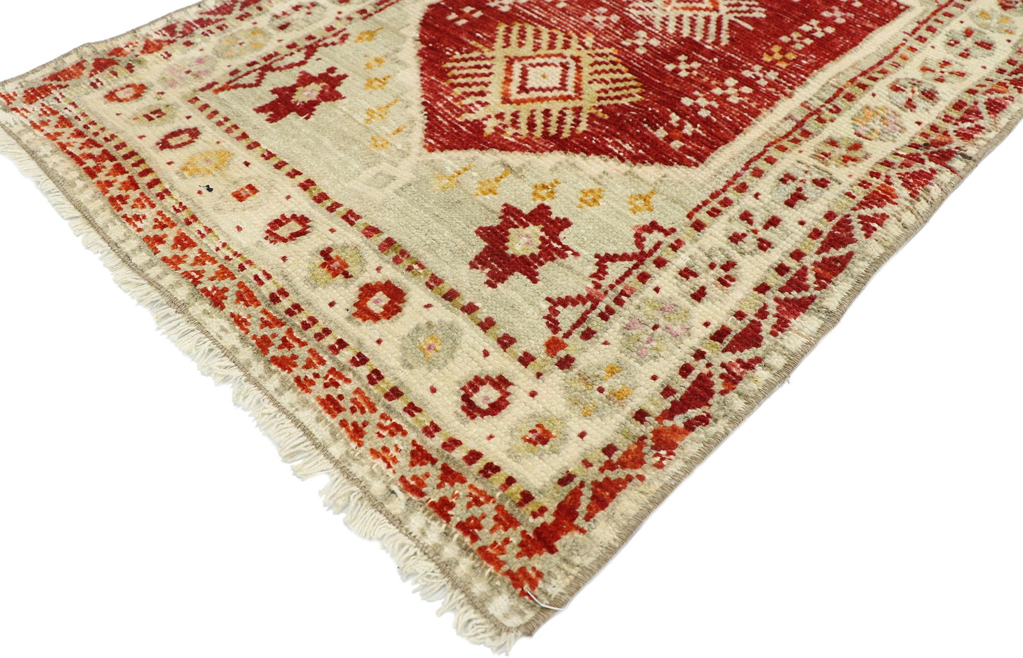 52723, distressed vintage Turkish Oushak Yastik rug, scatter rug. Immersed in Anatolian history and refined colors, this hand knotted wool distressed vintage Oushak Yastik rug combines simplicity with sophistication. A large ruby red backdrop