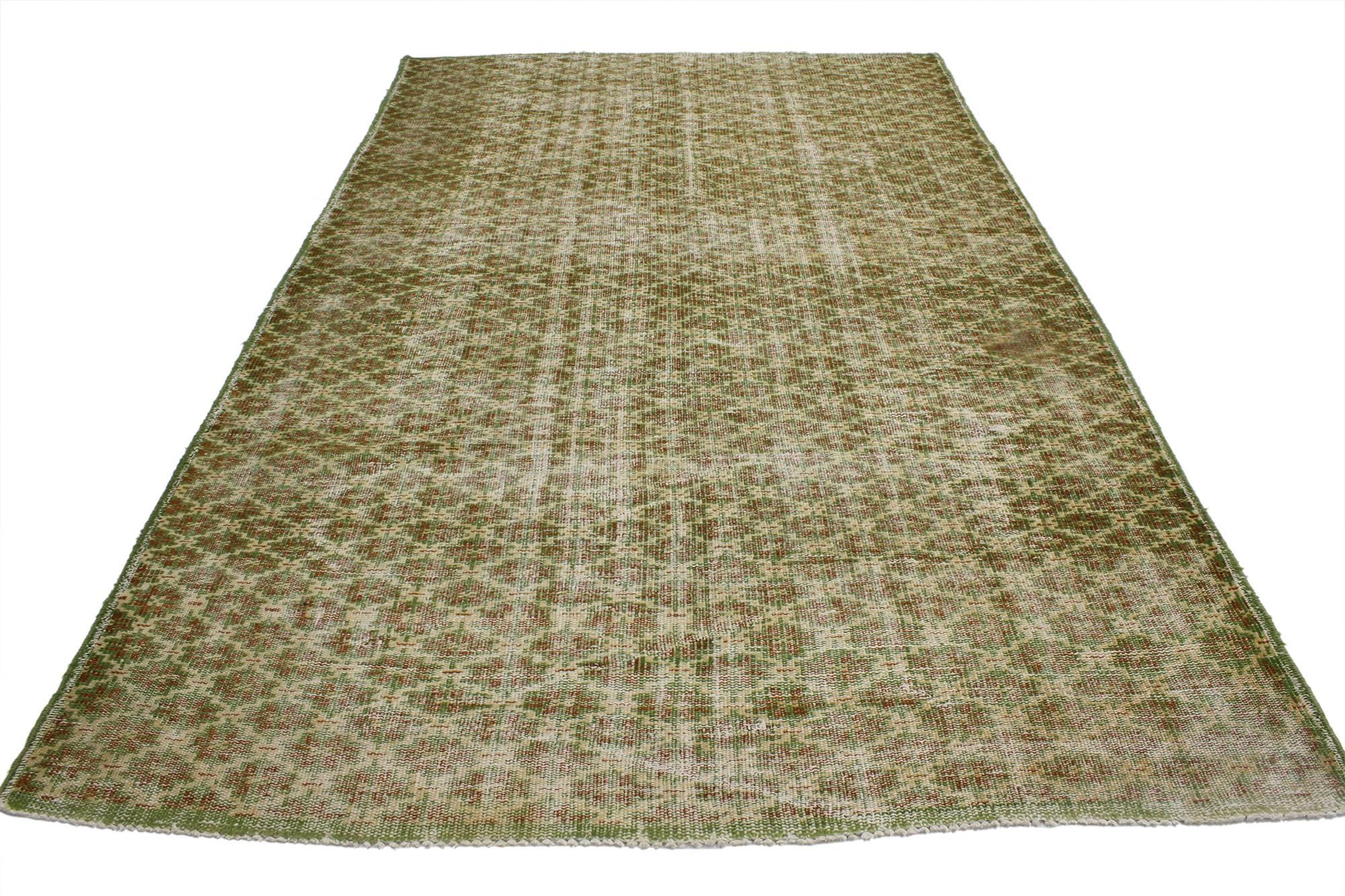 52003 Zeki Muren Distressed Vintage Turkish Sivas Rug with Industrial Art Deco Style. Warm and inviting combined with a bold pattern, this hand knotted wool distressed vintage Turkish Sivas rug embodies bold Art Deco style with a modern artisan