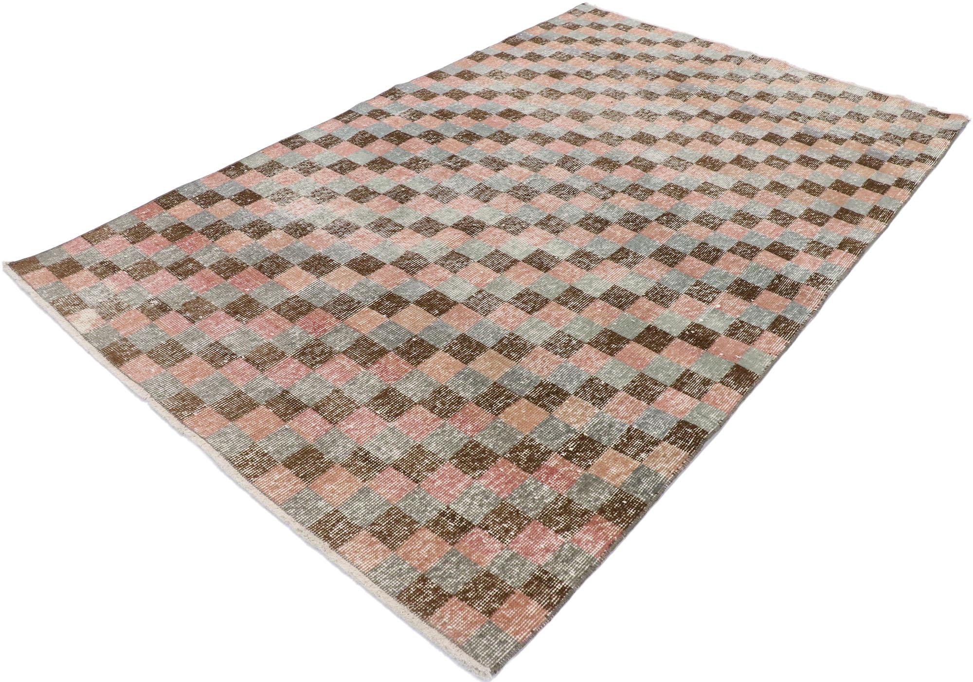 53275 distressed vintage Turkish Sivas rug with Modern Industrial Cubism style. The versatility of this rug lies in its simple, neutral checkerboard design comprised of rows of multi-colored squares and cubes. Whether running along a hallway in an