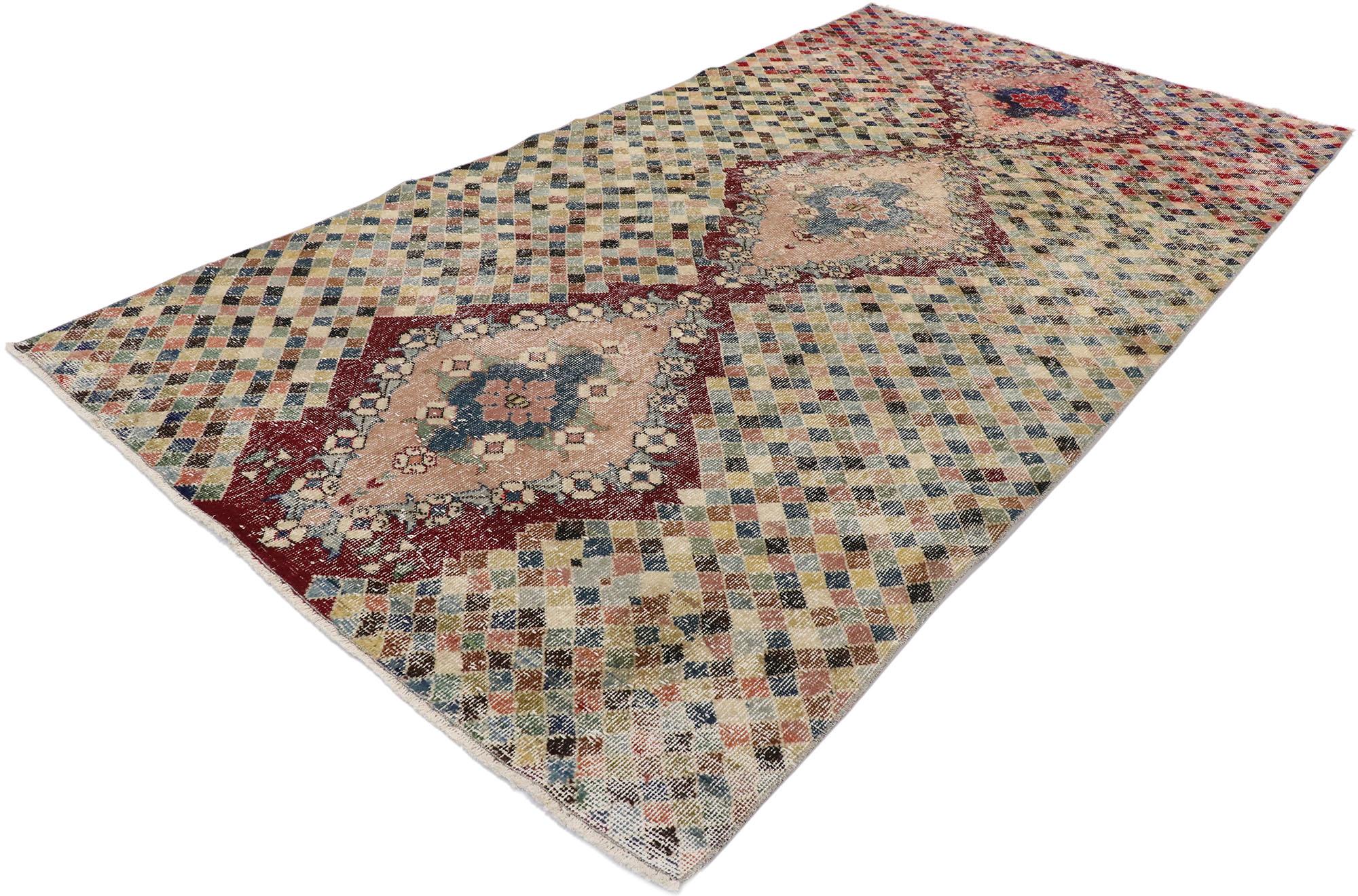 53336, distressed vintage Turkish Sivas rug with Romantic Cubist style. This hand knotted wool distressed vintage Turkish Sivas rug features three diamond-shaped medallions overlaid upon an all-over checkered backdrop. Each medallion is comprised of