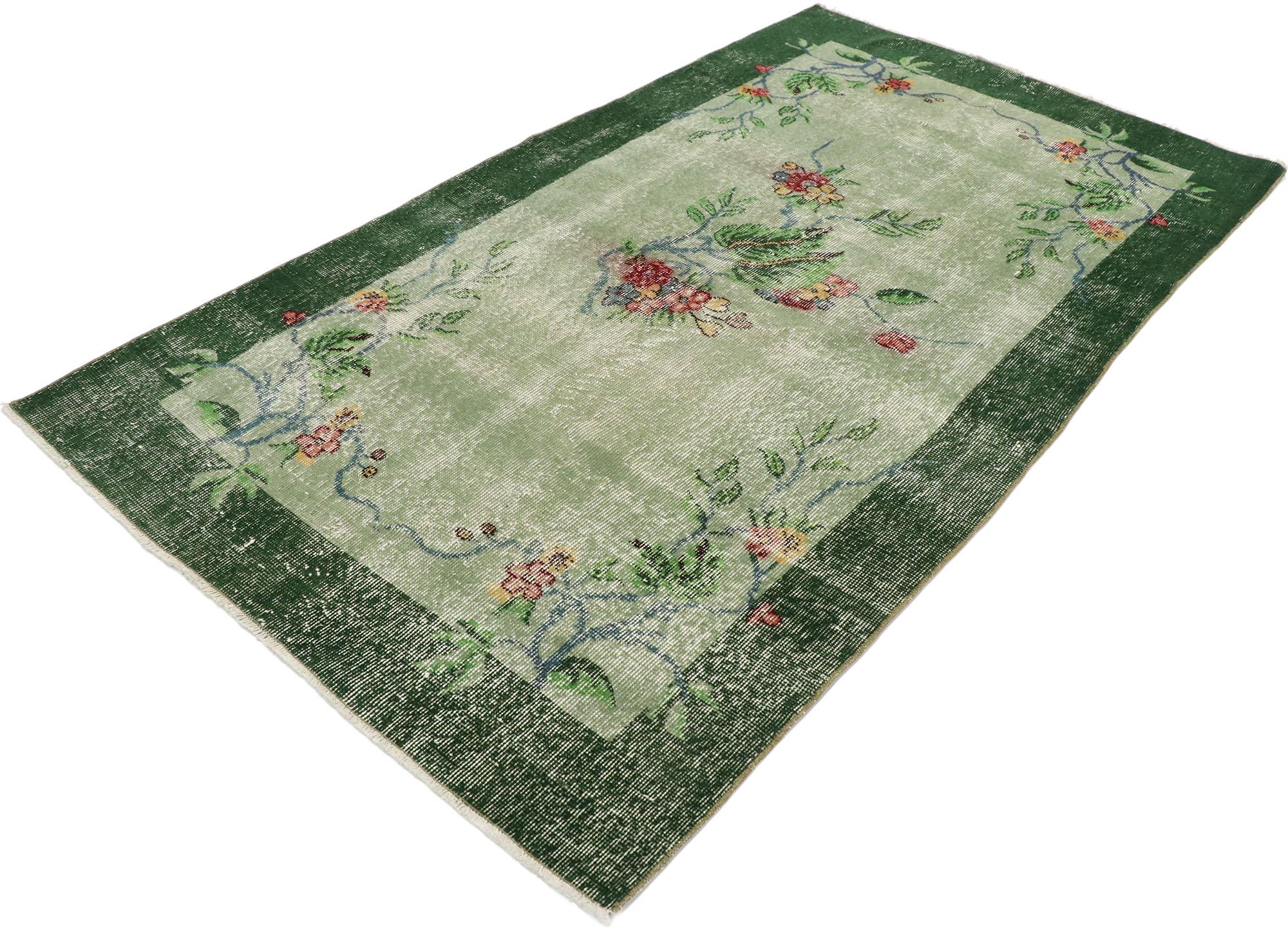 53373, distressed vintage Turkish Sivas rug with romantic Hollywood Regency style. This hand knotted wool distressed vintage Turkish Sivas rug features a color blocked plain field and border festooned with gorgeous floral motifs. A large spray of