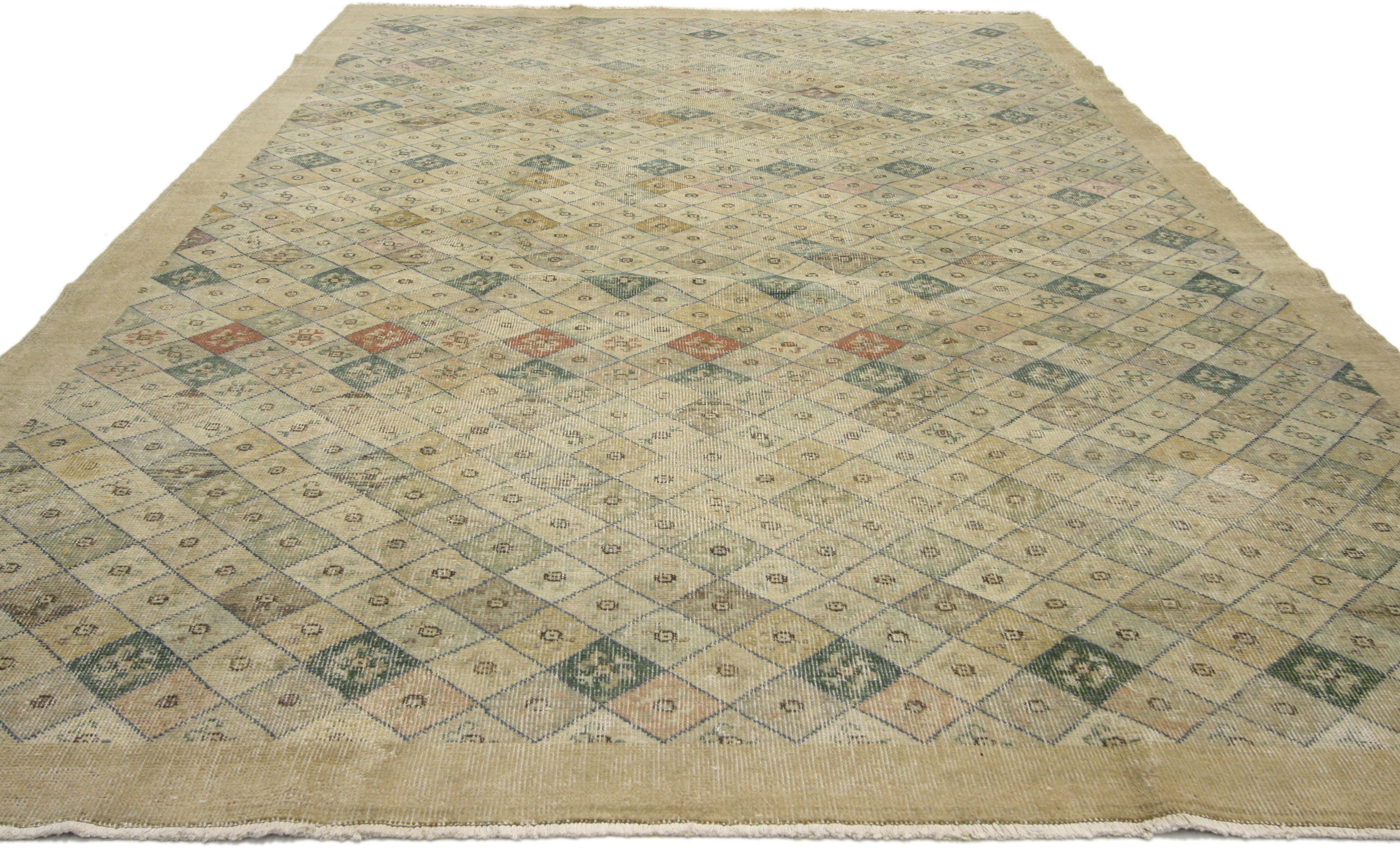 51015, distressed vintage Turkish Sivas rug with shabby chic Farmhouse style. This hand knotted wool distressed vintage Turkish Sivas rug features a diamond lattice pattern comprised of small diamonds in alternating colors. Each diamond contains a