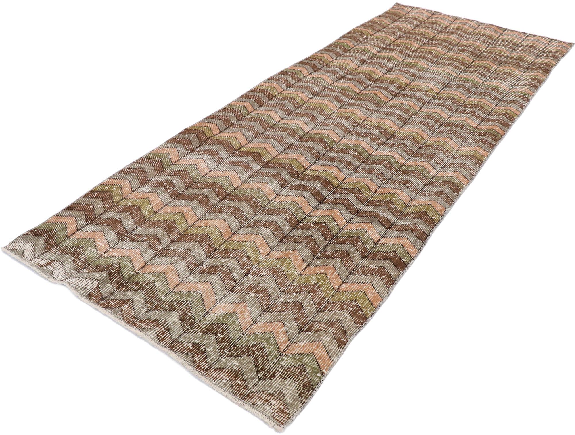 53284, distressed vintage Turkish Sivas Runner with Rustic boho chic style. This hand knotted wool distressed vintage Turkish Sivas runner features an all-over chevron pattern in rows of alternating colors. Gentle waves of Abrash and variations in