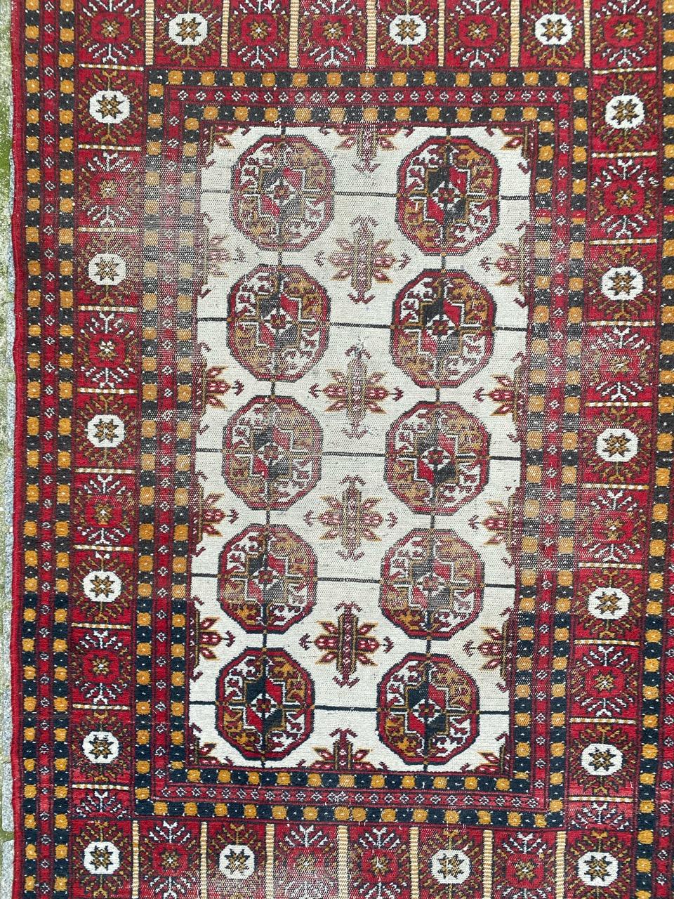 Turkmen Afghan rug with a geometrical Bokhara design and beautiful colors, entirely hand knotted with wool velvet on cotton foundation.