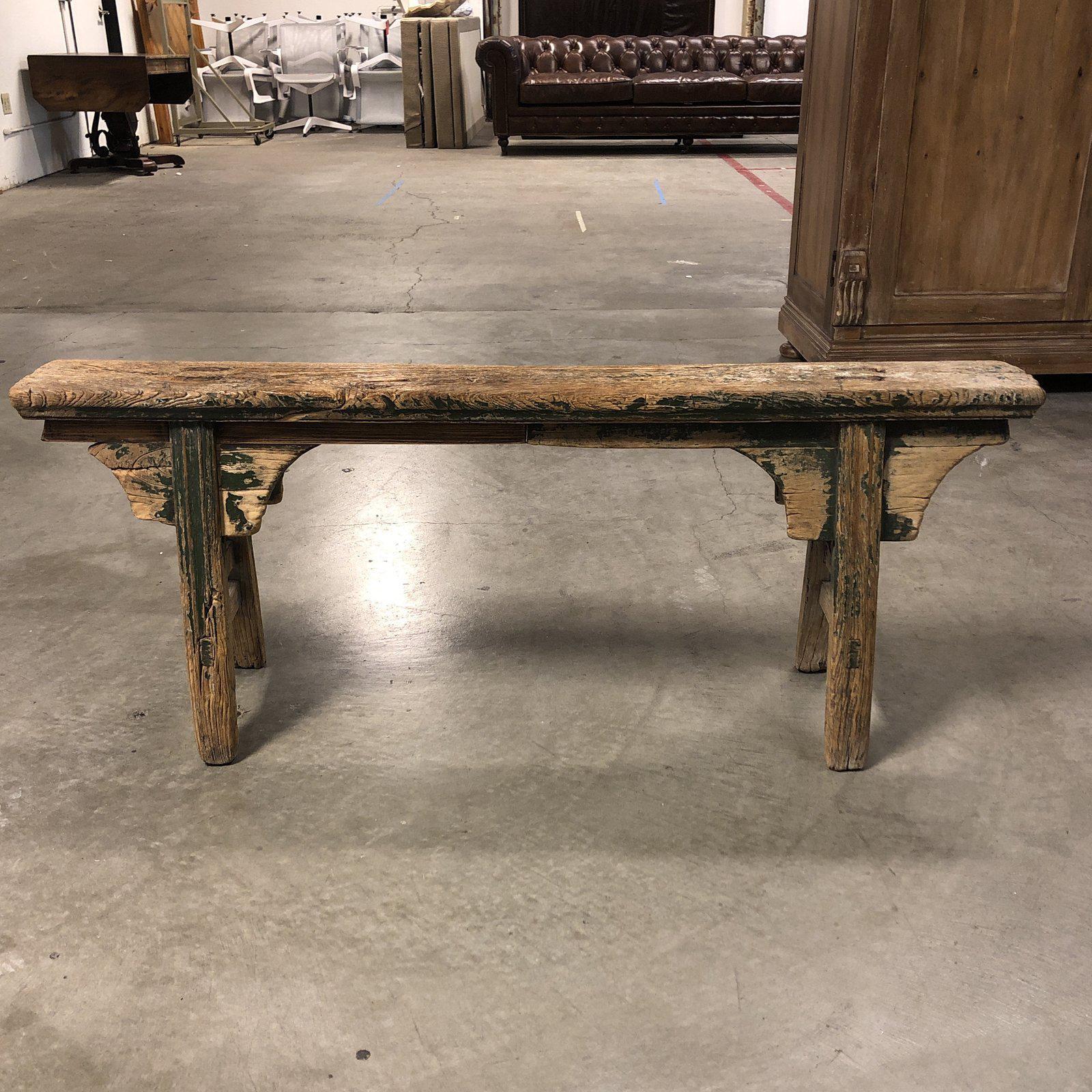 A vintage wood Asian bench. Constructed of solid wood with natural distress. The original finish is a forest green, now with natural wood exposed due to aging. Narrow in size, can fit in any room.