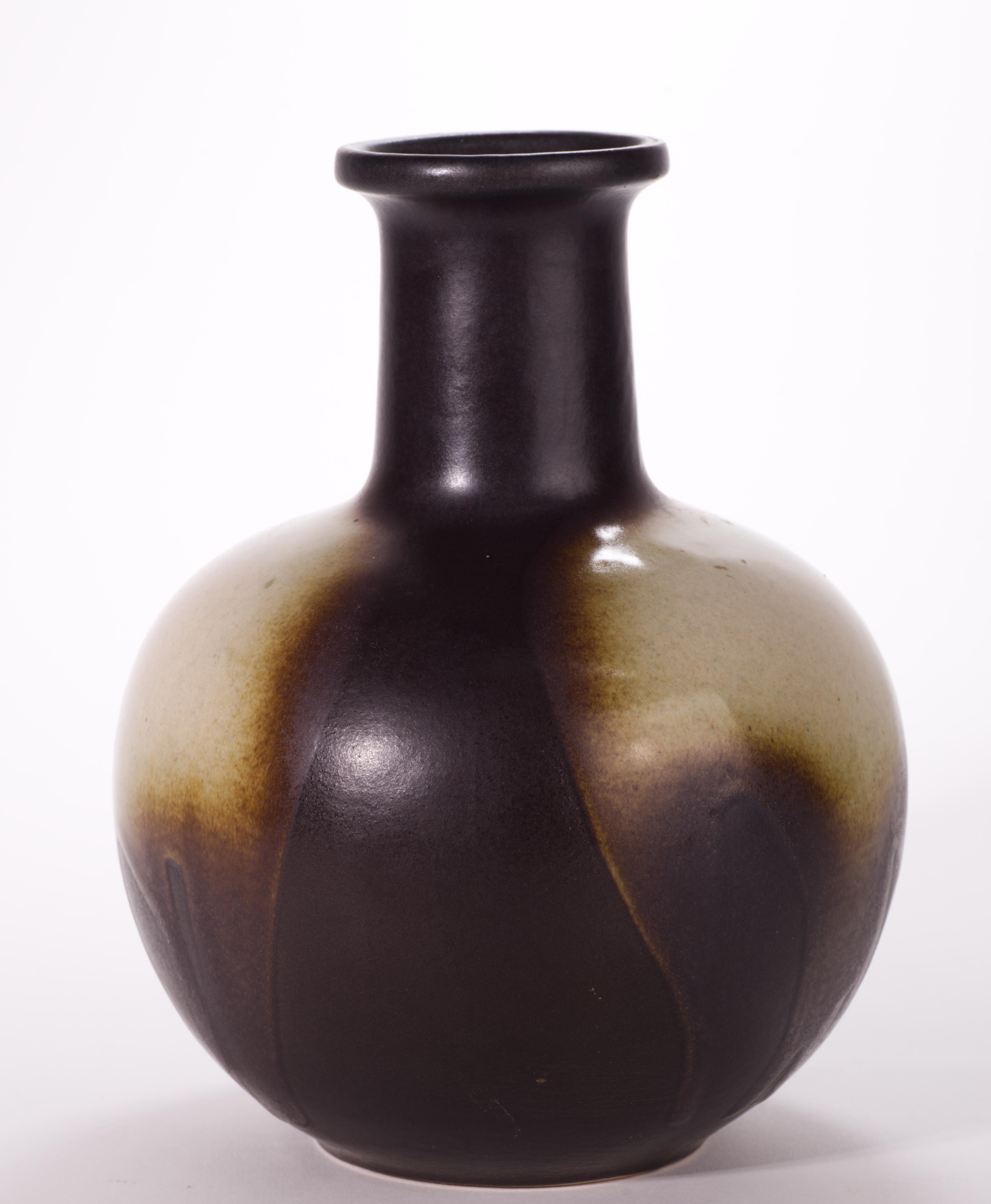  Graphic ceramic vase with glazed finish was produced by Ditmar Urbach in 1960s. It is decorated with a combination of light beige and clear glossy drip glazes on semi-matte deep brown background glaze, in what is known as 'Brussels Style', a term