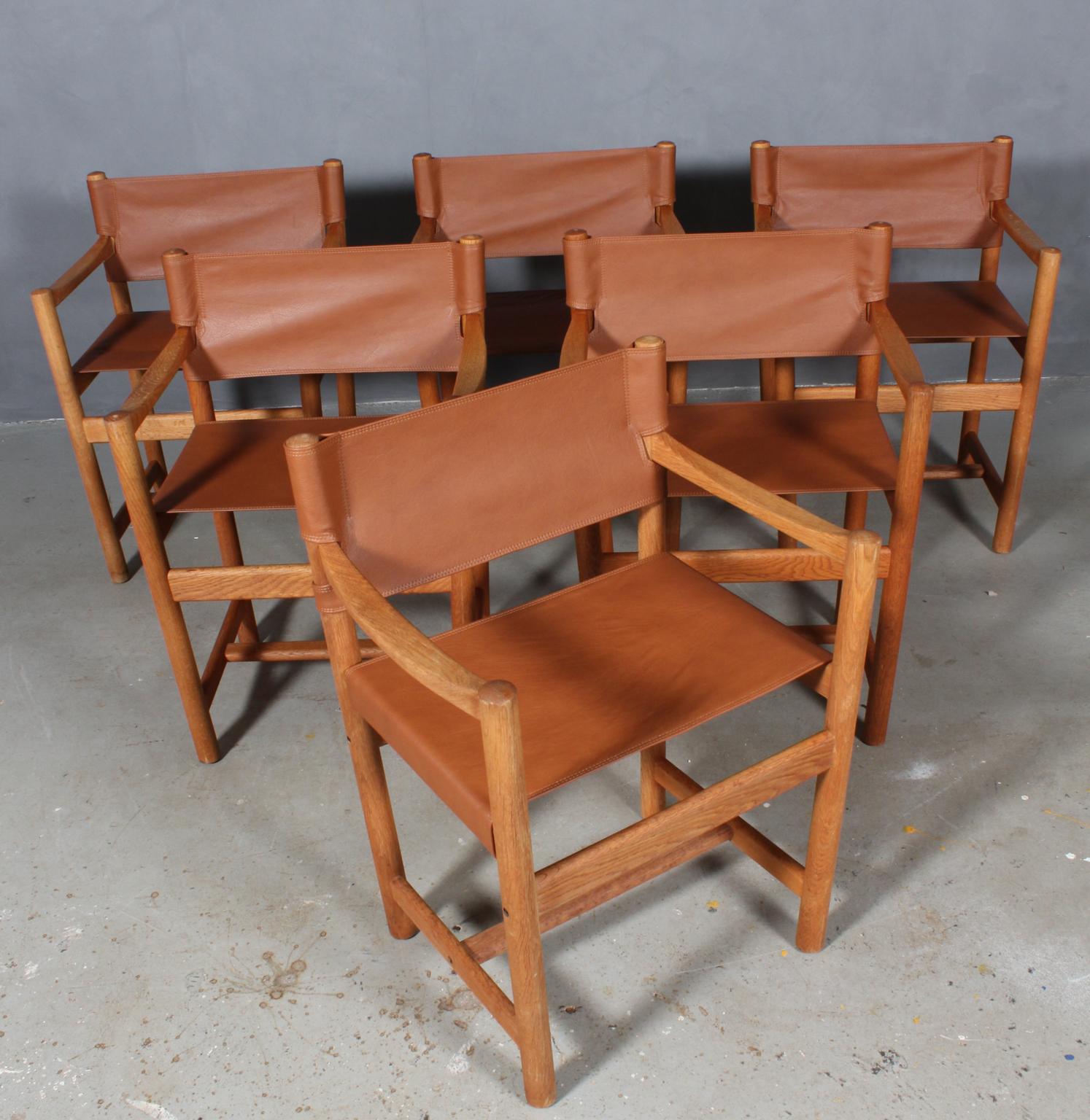 Ditte Heath armchairs in oak. 

New upholstered with tan aniline leather.

Model J102, made by FDB.