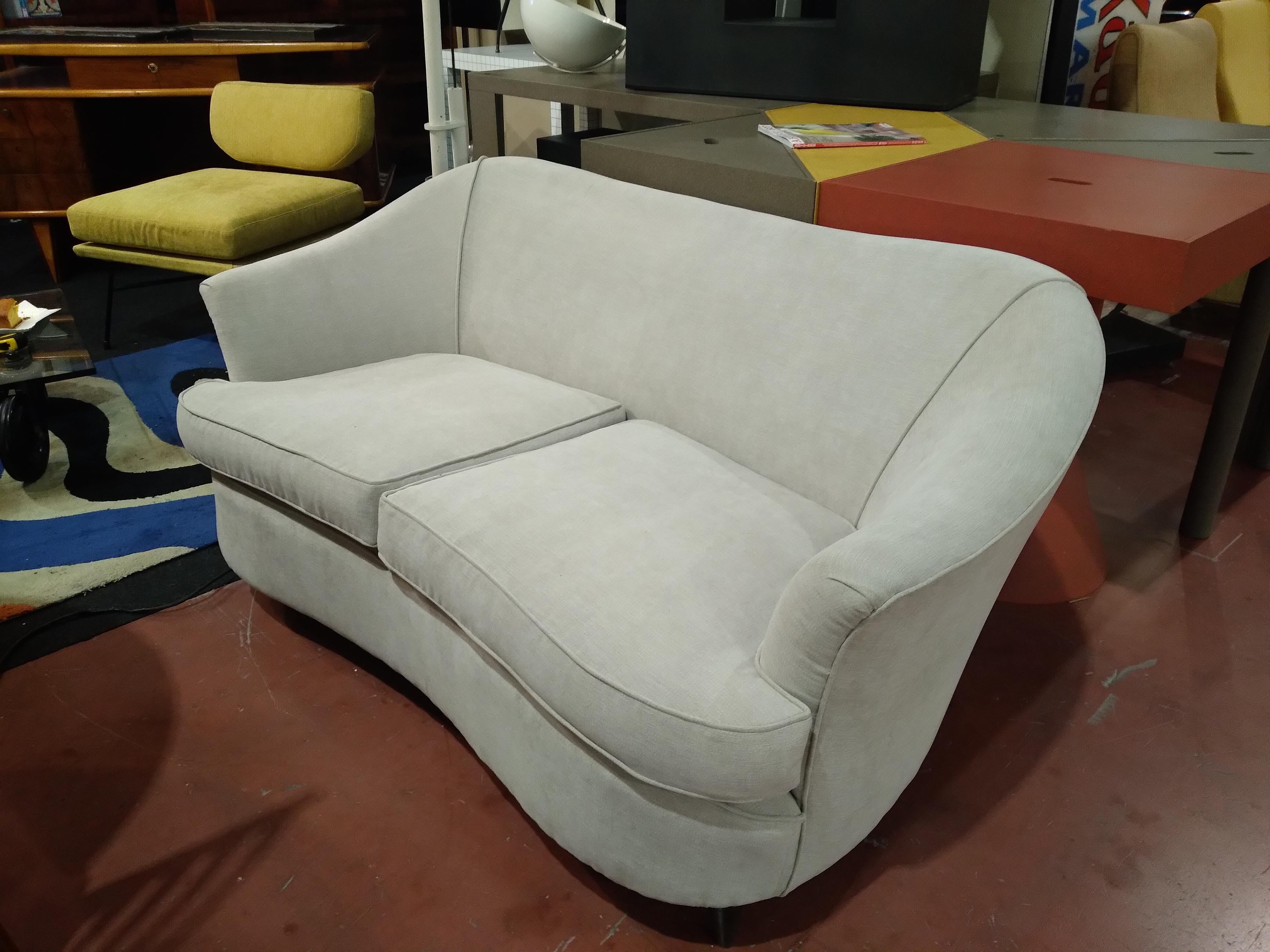 Sofa by Gio Ponti for Home and Garden 1950 .This sofa is a two-seater , it is a sofa with soft and enveloping lines , with its   rounded line is a design icon of the 1950s .It sets with great lacility in any environment , has been arranged in the
