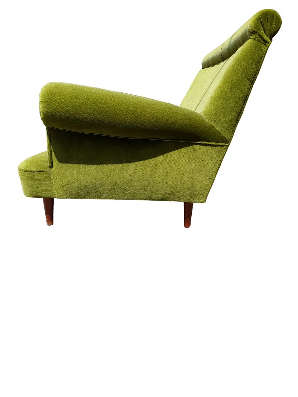 Elegant 1960s Italian upholstered sofa, perfect for adding a vintage and sophisticated touch to any room. This two-seater sofa is upholstered in a soft green velvet whose tone evokes the colors of nature. The upholstery was recently renovated, which