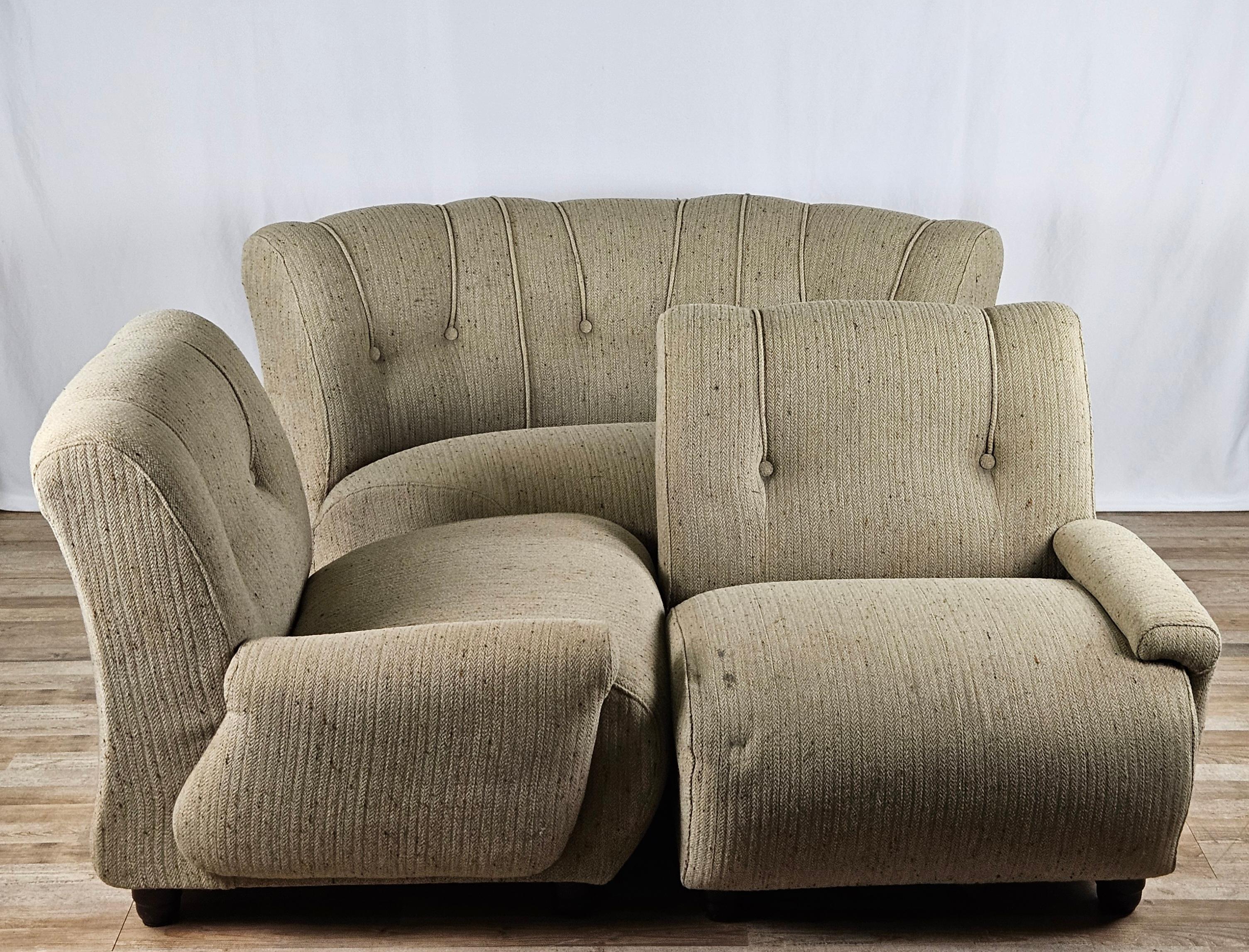 Mid-century modular sofa consisting of four comfortable gray fabric seats with wooden feet.

It can be used in different compositions, with the corner seat and the two side seats or with just the three standard seats.

It shows normal signs of wear