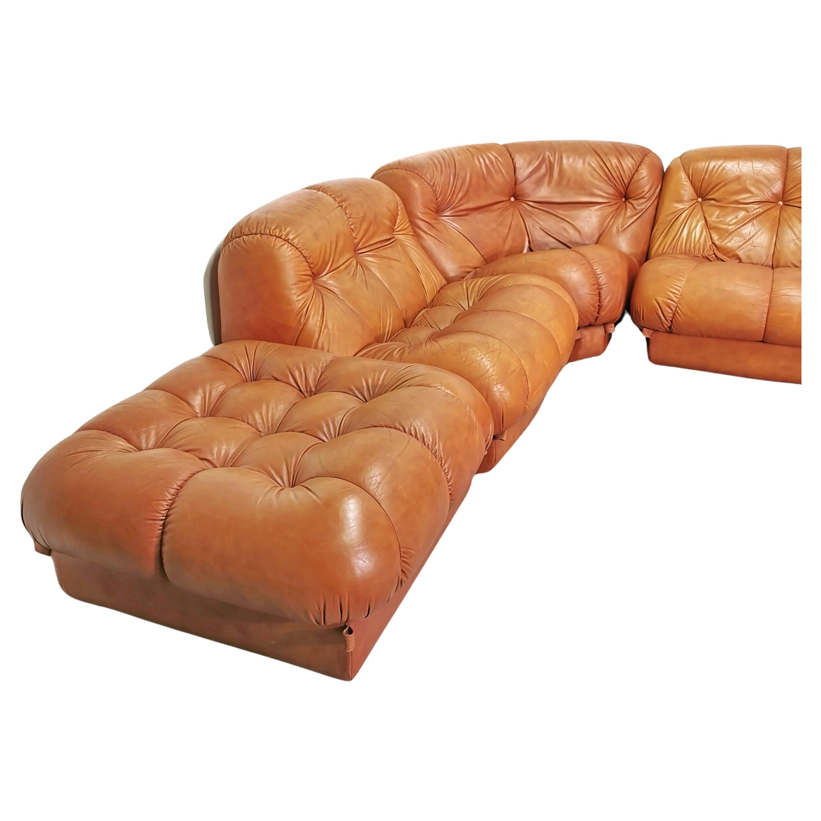 Modular cognaq leather sofa Nuvolone model designed in the 1970s by Rino Maturi for Mimo Design. the sofa is composed of  by 5 seats including 1 ottoman and a corner module. the Sofa is in very good condition with minor signs of time.
has no plastic