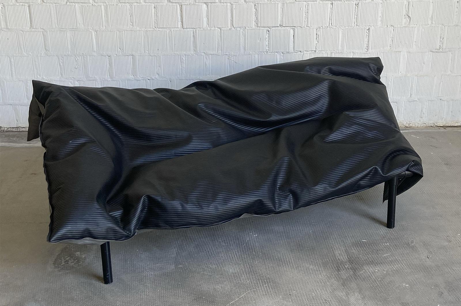 Sofa designed by Ron Arad for One/Off in 1985. The sofa consists of a rigid lacquered steel Kee-Klamps frame on which the seat cushion is placed, made of PVC filled with unfoamed polystyrene granules.The Transformer is designed to adapt to the