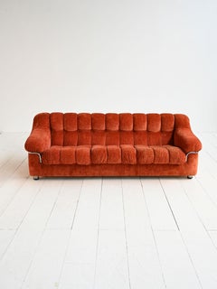 Vintage 1970s rust-colored velvet sofa with metal details