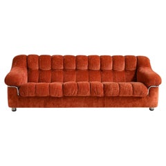 Vintage 1970s rust-colored velvet sofa with metal details