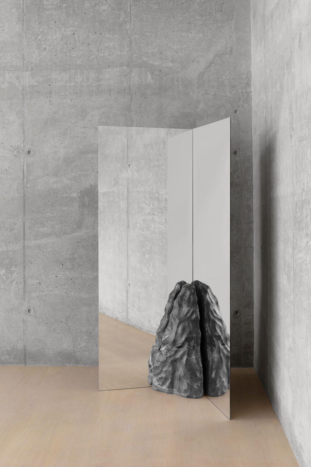 Divergente double mirror by Andres Monnier.
One of a Kind.
Dimensions: W 100 x L 80 x H 180 cm.
Materials: grey quarry stone, glass (mirror).

The piece inspired by a convergent plate boundary, the location where two tectonic plates are moving