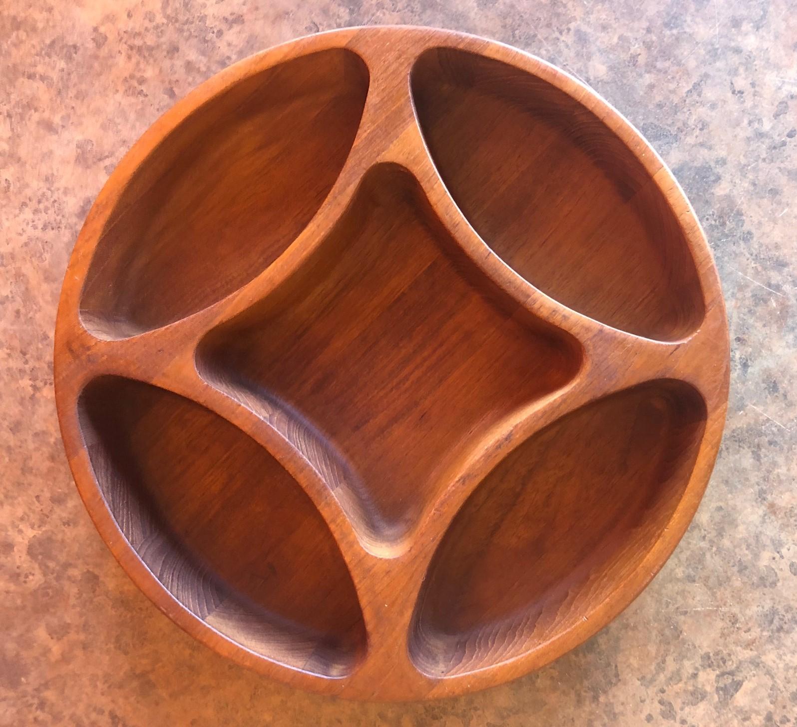 Unique divided bowl in teak by Jens Quistgaard for Dansk, circa 1970s. The bowl is quite functional with five different walled sections and is in excellent condition.