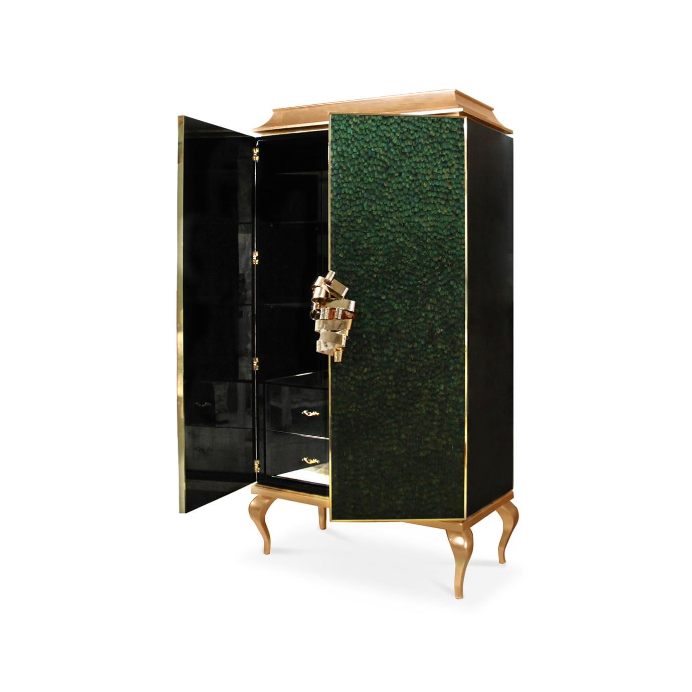 This utterly desirable double-door pagoda top armoire is covered in delicate, individually placed natural feathers. An exquisite metal ribbon opens the doors to a lavish interior graced with four drawers and two adjustable shelves. The top and base