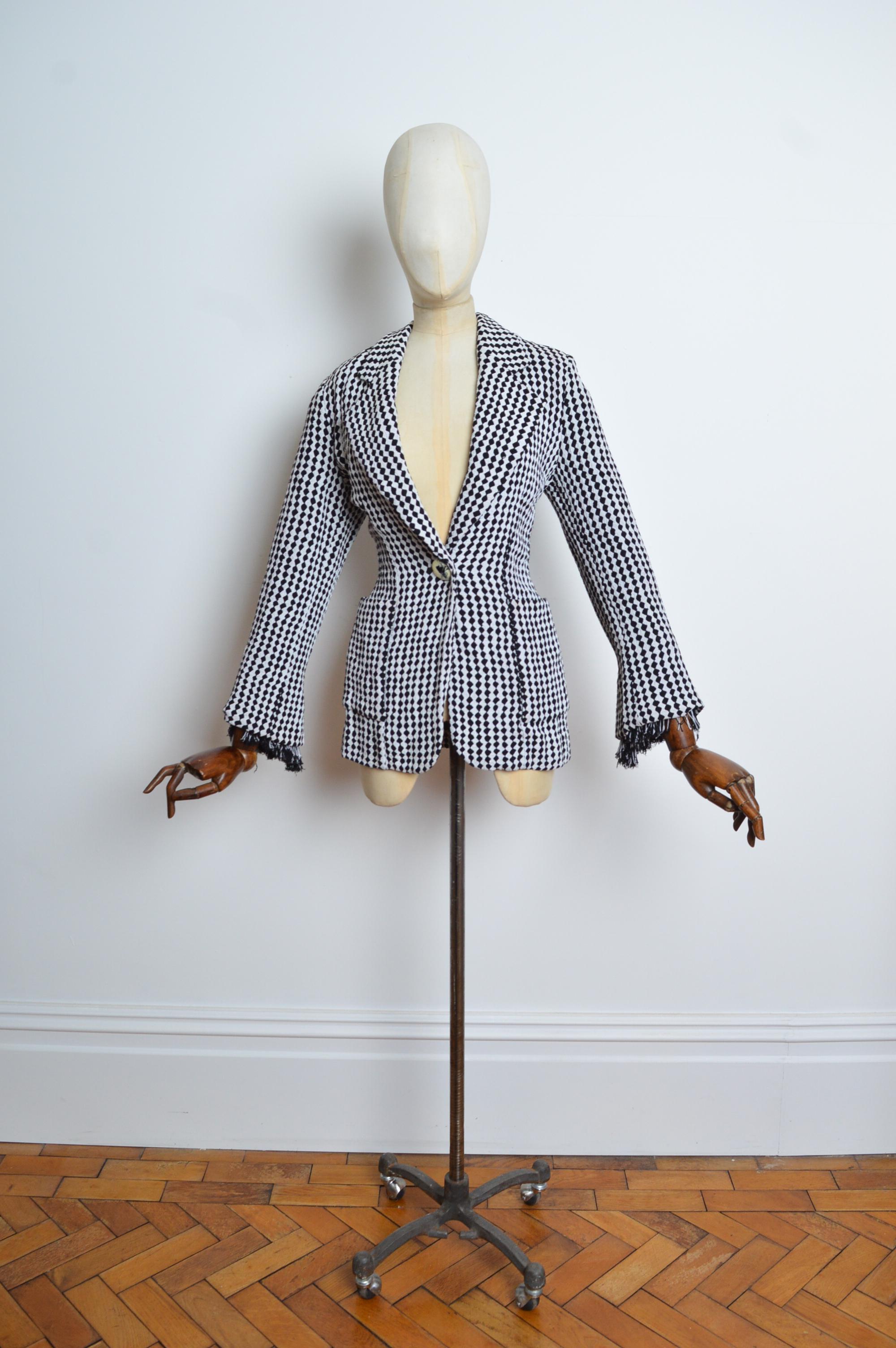 A Superb Gianfranco Ferré for Christian Dior Blazer, crafted from a stretchy Black and White diamond patterned material with bead & fringe detailing at the cuffs and singular button closure at the Waist. (1989-1996).
Size; Recommended to fit a U.K.