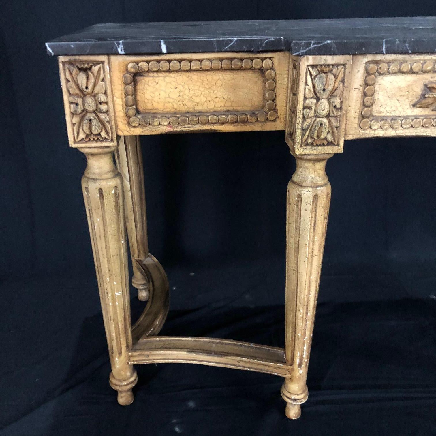 Louis XVI style console table having white and gold veined black marble top on very well carved frieze and legs and a painted antique ivory.
 # 5147.