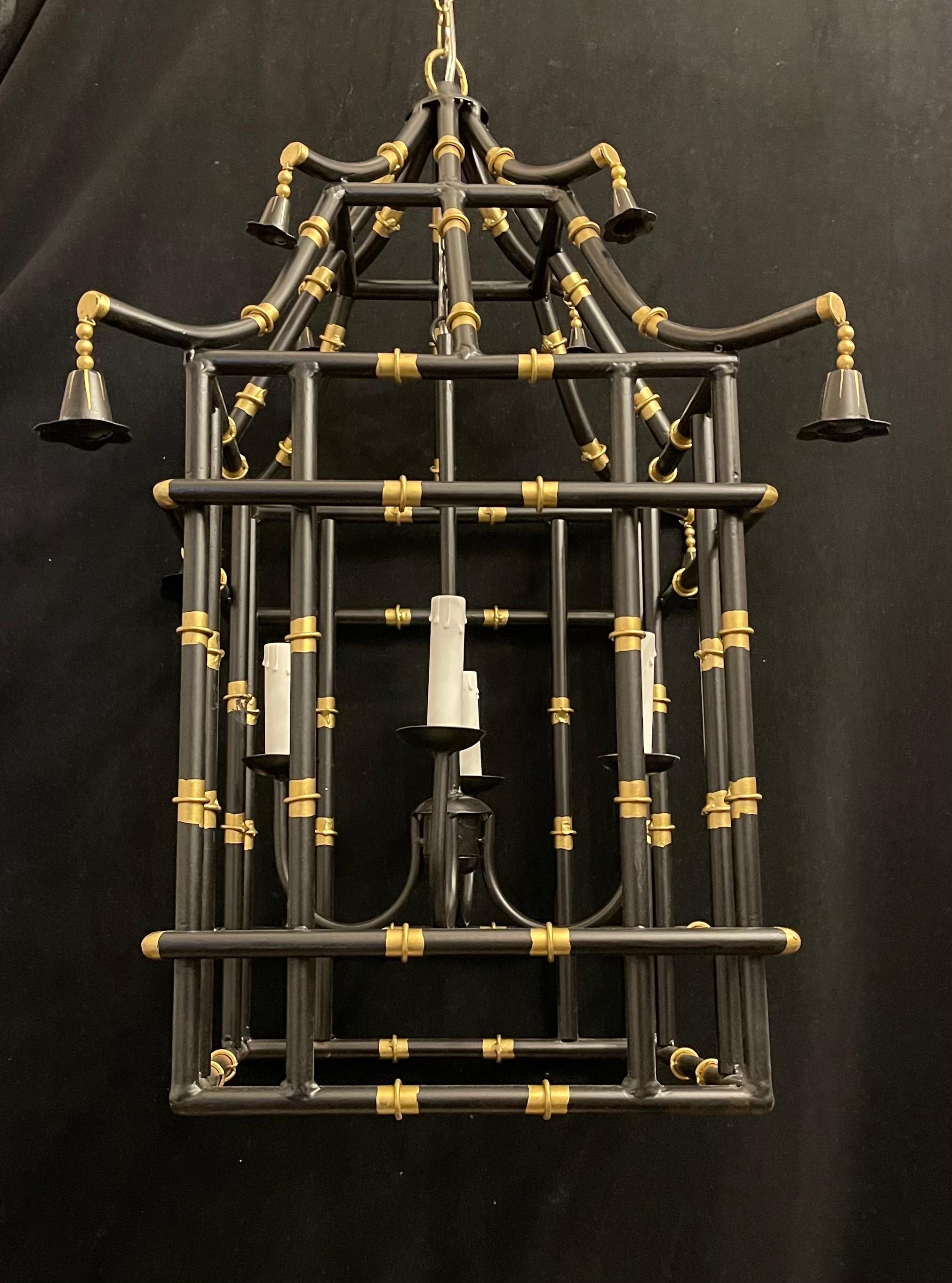 A divine large pair of black & gold gilt pagoda bamboo form chinoiserie lanterns, each of the fixtures have been rewired and come with chain canopy and mounting hardware for installation.