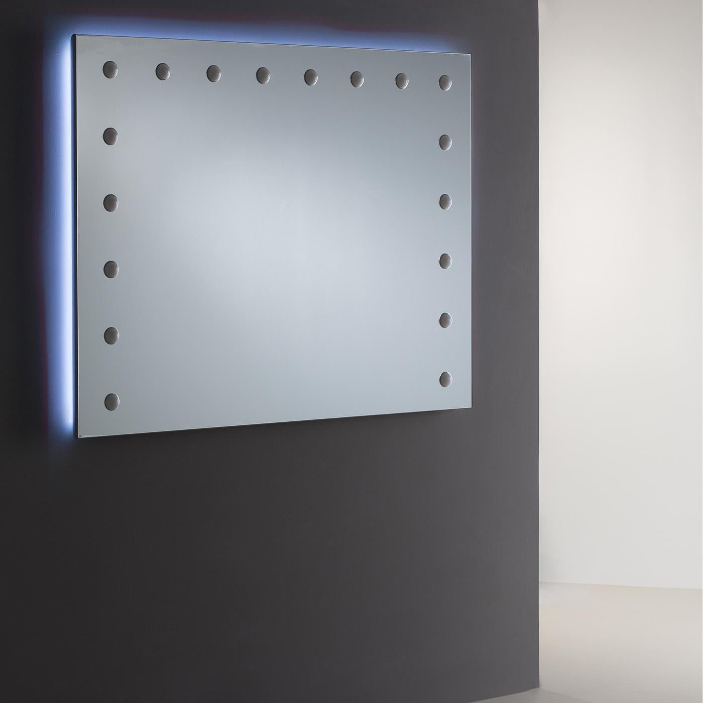 Premium quality and modern elegance make lighted mirror the perfect choice for a bedroom, bathroom or entryway. Illuminated by 18 I-light set behind opaline lenses, cut with precision into the reflective surface, this rectangular wall mirror is