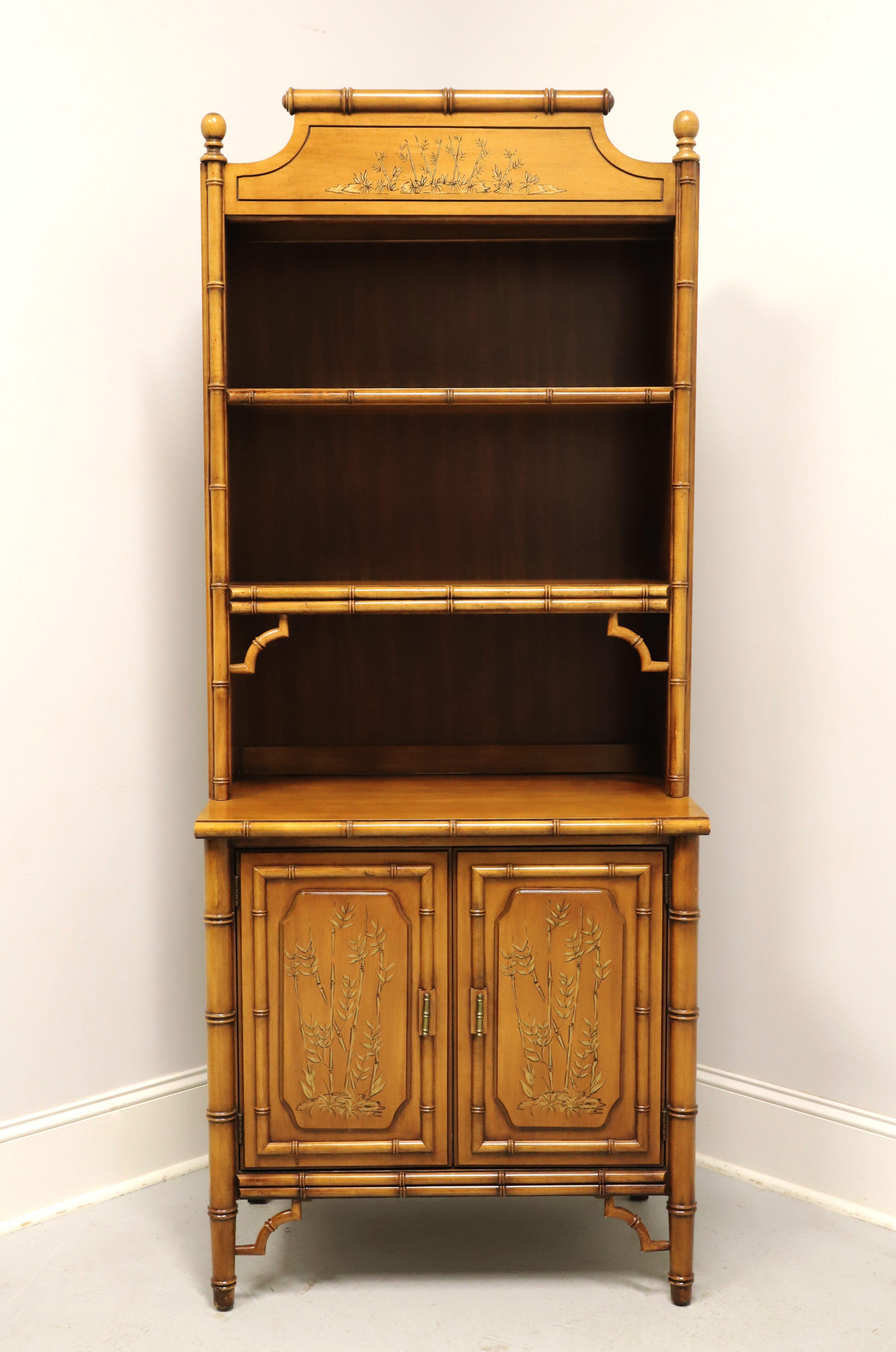 An Asian chinoiserie style bookcase hutch with cabinet chest by Dixie Furniture, from their Aloha Collection. Faux bamboo wood with hand painted chinoiserie scene on the doors & top, decorative scroll like top with finials, brass hardware, and