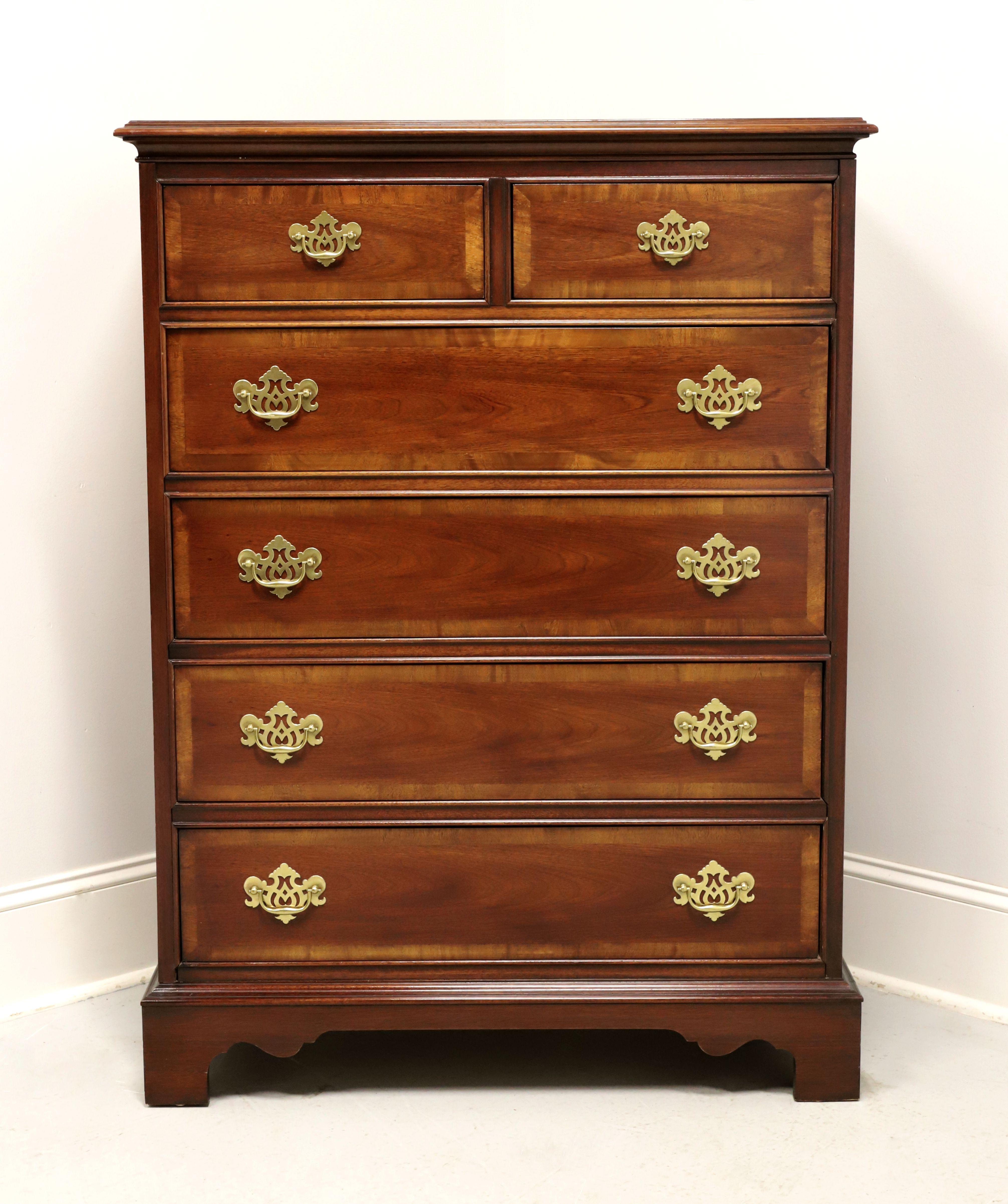 A Chippendale style chest of drawers by Dixie Furniture. Mahogany with brass hardware, banded inlaid top with bevel edge, banded drawer fronts, and bracket feet. Features two smaller over four larger drawers of dovetail construction. Made in Lenoir,
