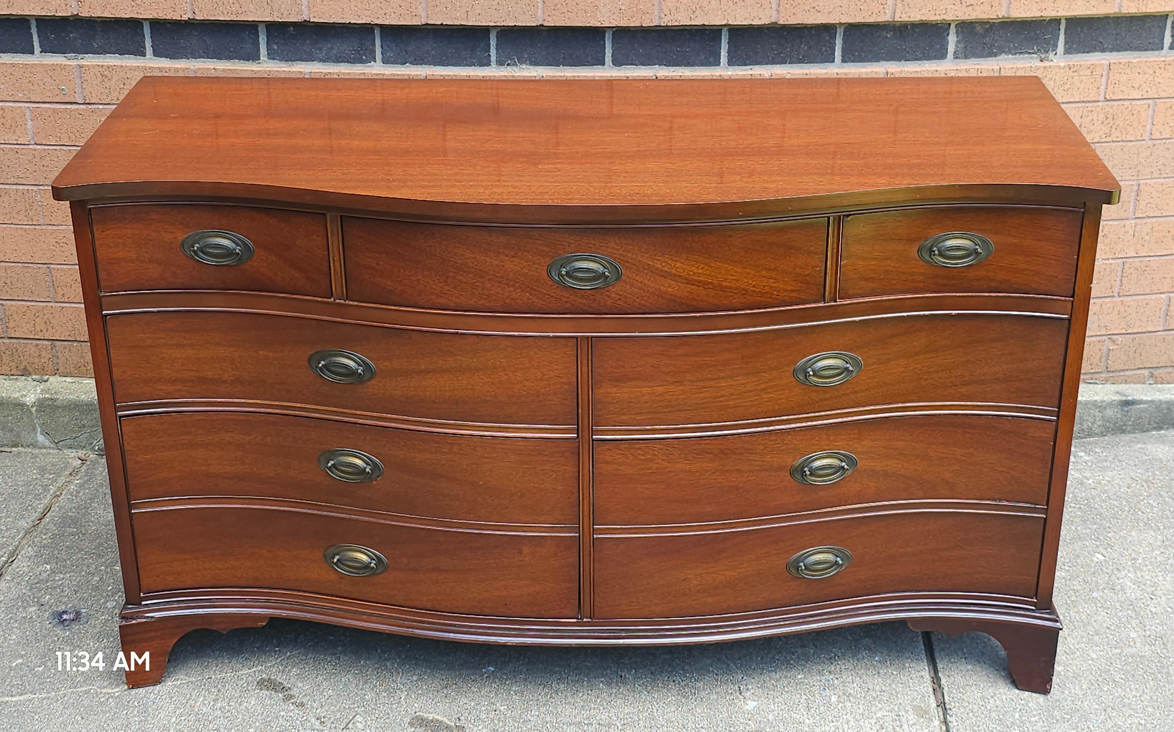 Dixie Furniture Federal Style Mahogany Sepentine Double Dresser with protective Glass Top. Dovetail Drawers functioning flawlessly. Measures 55