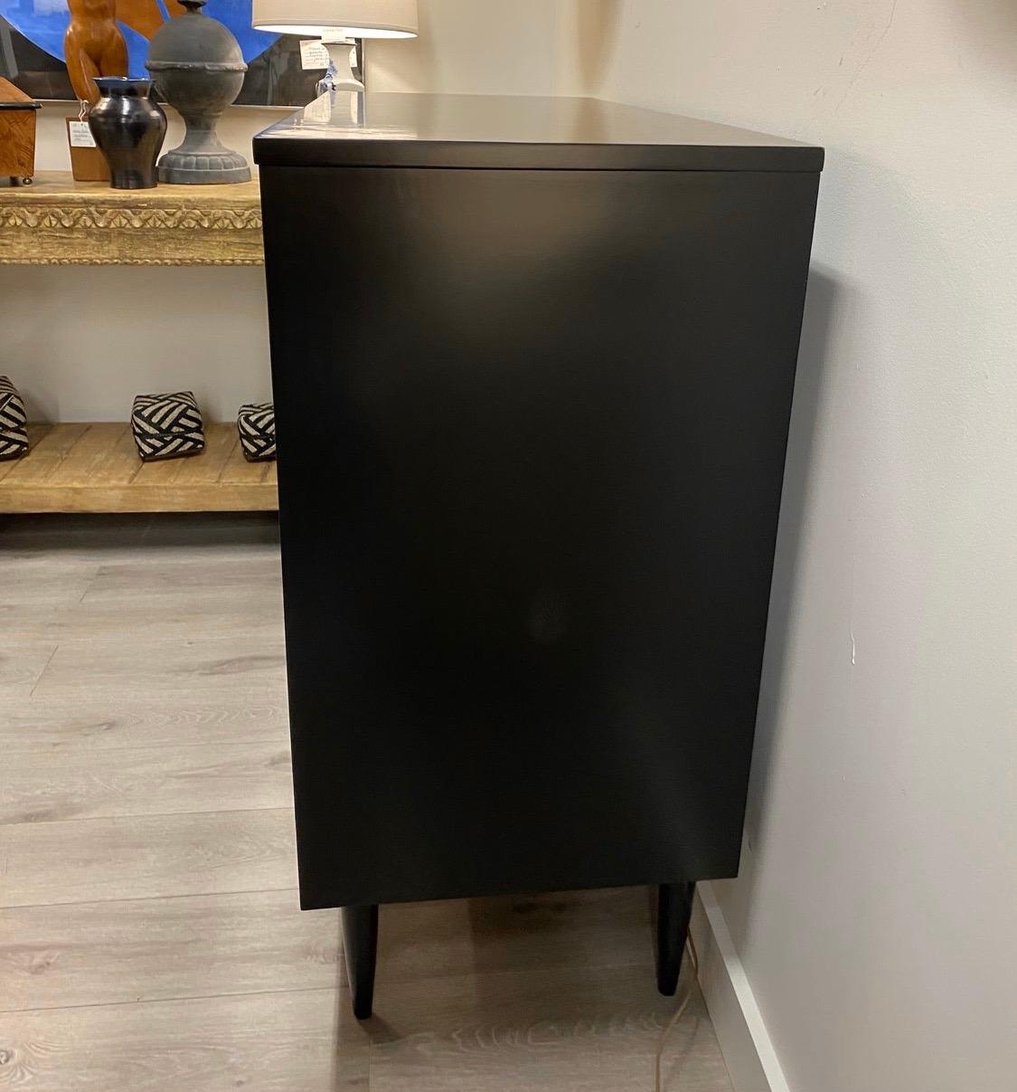 Newly lacquered in a flat black color, Dixie dresser with multiple drawers for all your storage needs.
The black lacquer breathes new life into this iconic beauty. Great scale and better lines.
