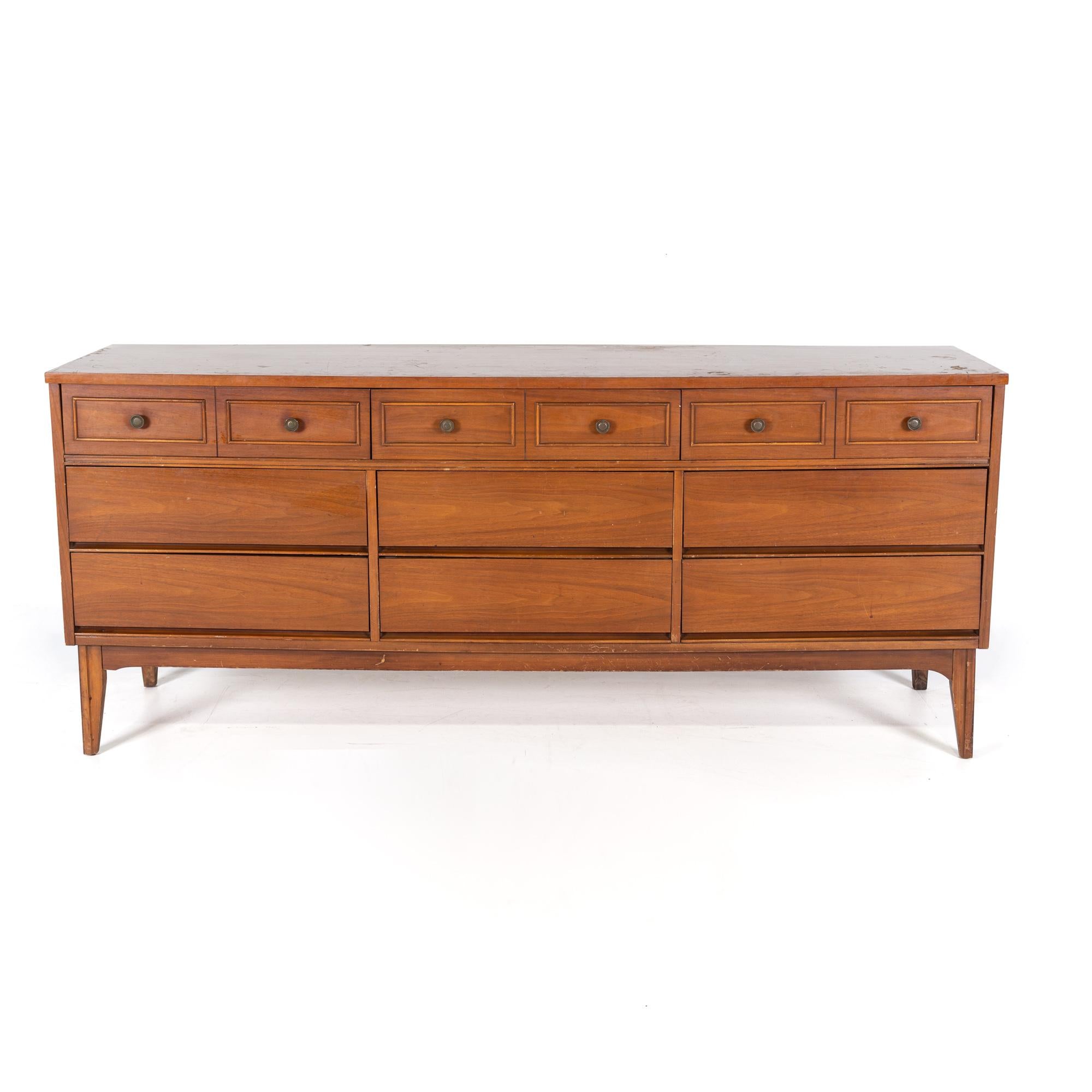 Dixie Mid Century Walnut 9 Drawer Lowboy Dresser

The dresser measures: 72 wide x 19.5 deep x 30.5 inches high

All pieces of furniture can be had in what we call restored vintage condition. That means the piece is restored upon purchase so it’s