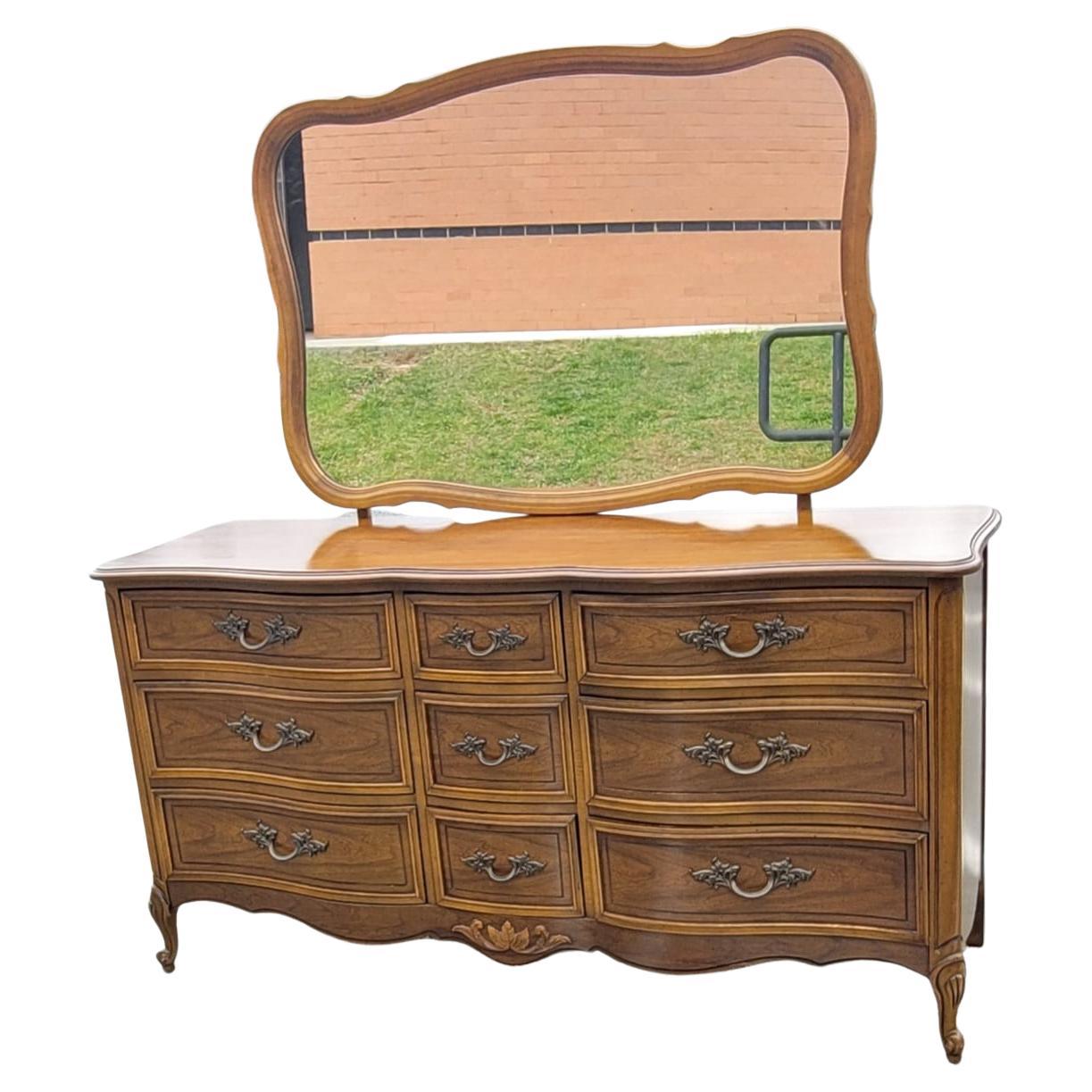 Dixie Provincial Style Walnut Fruitwood Triple Dresser With Mirror. Very solid construction with original French drawer pulls and featuring 9 drawers, all with hand-cut dovetail joints construction and functioning as originally intended. Mirror