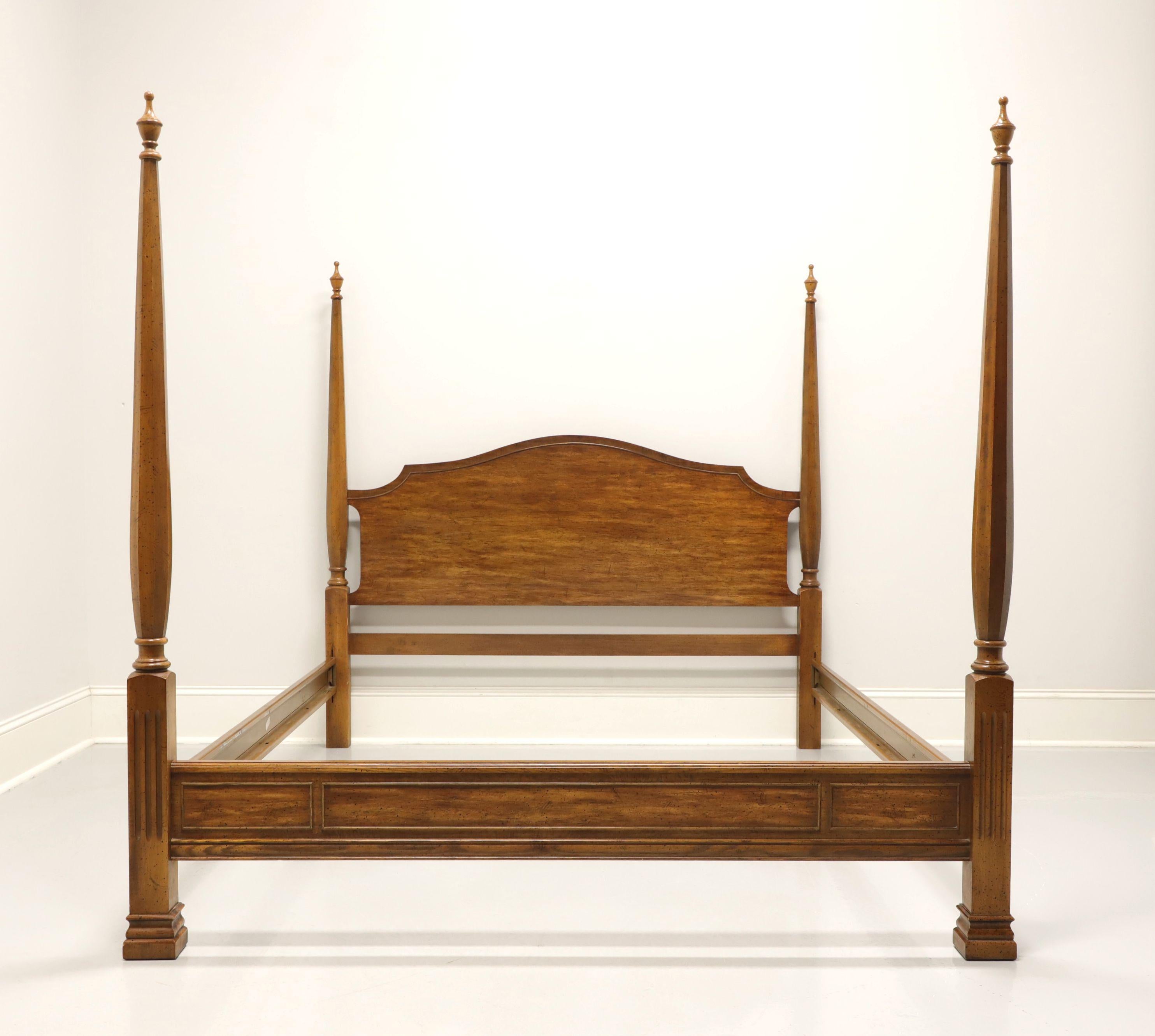 A Chippendale style queen size poster bed by Dixie Furniture, from their Sheffield Manor Collection. Pecan headboard and footboard with clip held wood grain metal side rails. Features headboard with two turned posts with finials and footboard with