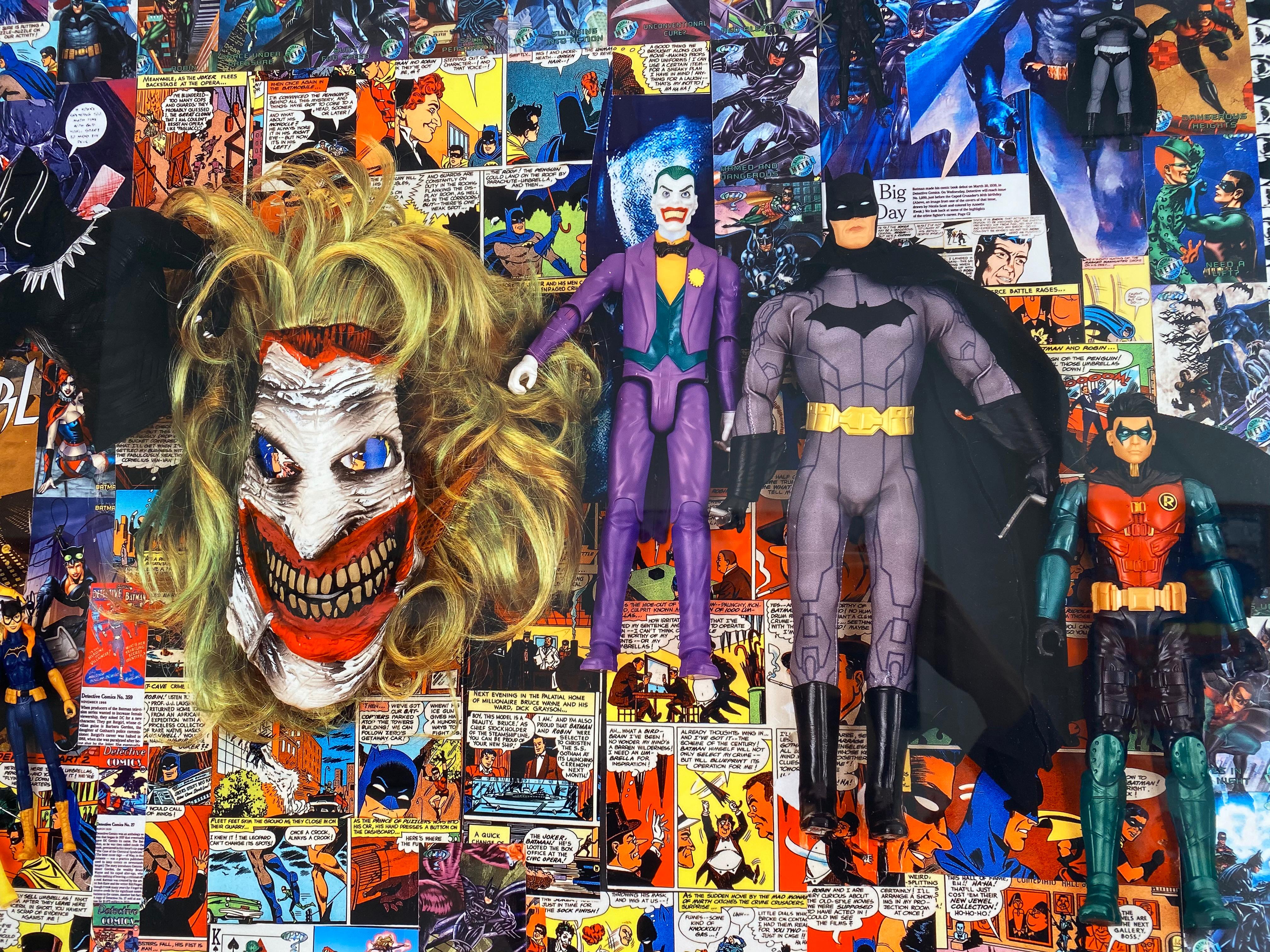 'Batman and Friends' by DJ Leon, 2020. The print measures 25 x 32 inches and is also available in a 30 x 23 3D backlit print. This dye-sublimation print on aluminum combines and appropriates Batman imagery along with commercial memorabilia such as