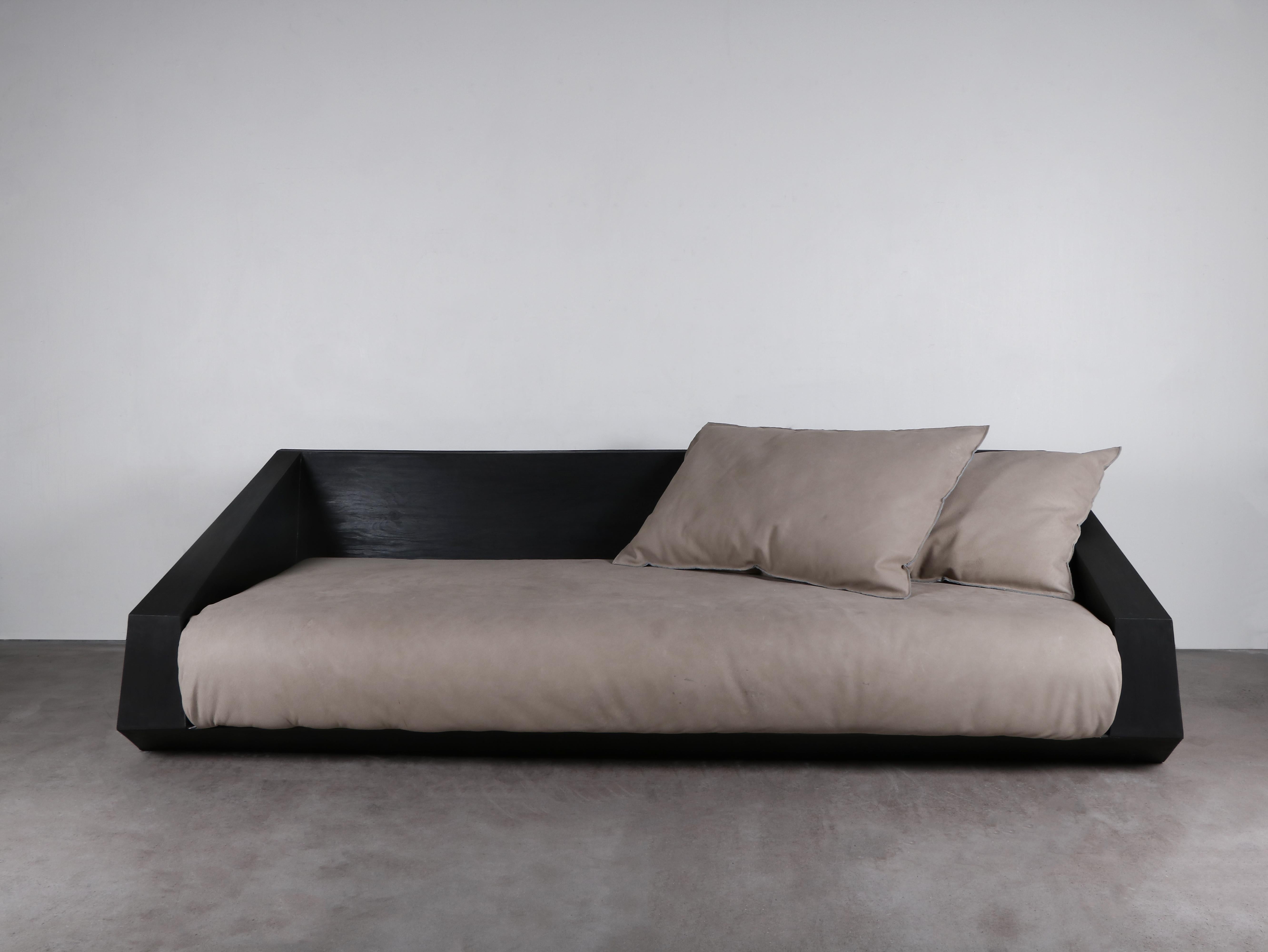 Djup sofa by Lucas Tyra Morten
Limited Edition of 15
Dimensions: L 240 x W 103 x H 65 cm
Material: Hand waxed plywood, leather

Occupying the liminal space between art and design, the multidisciplinary atelier of Lucas and Tyra Morten is a small