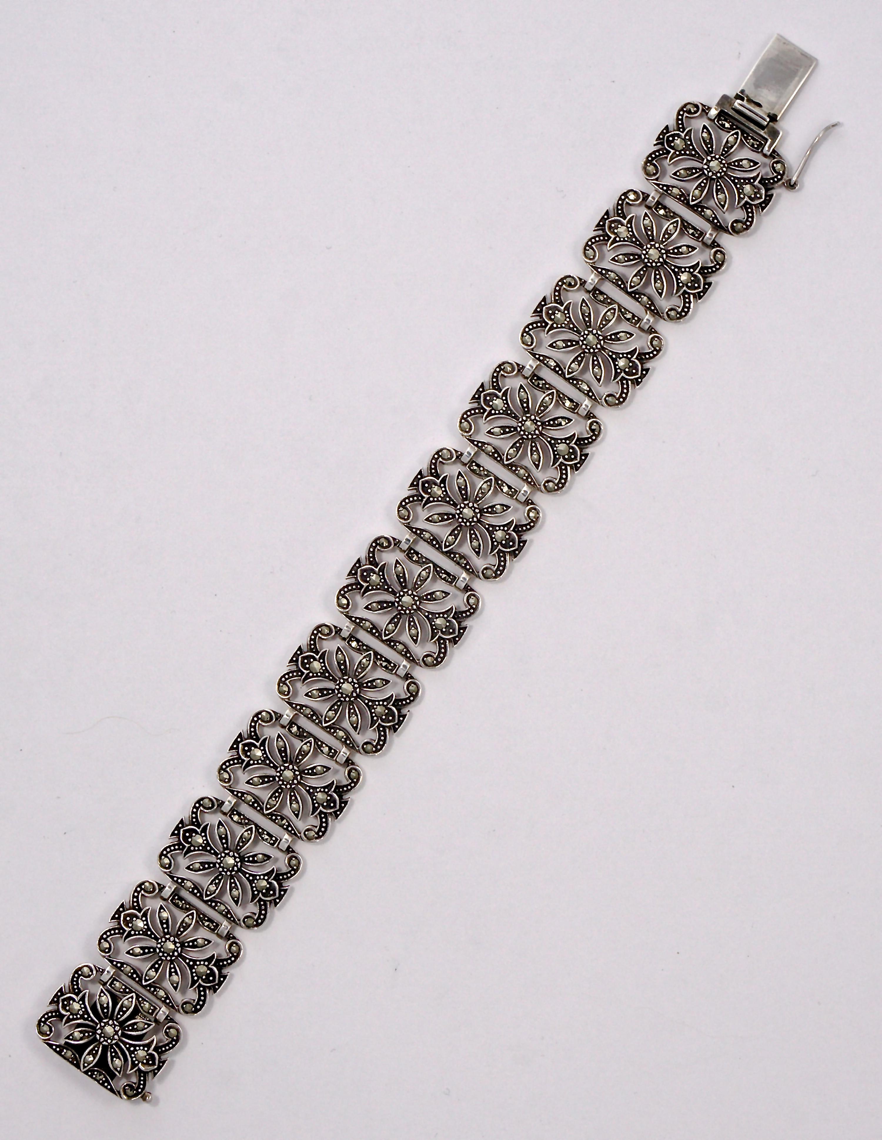Sterling silver panel link bracelet, embellished with marcasites. Measuring length 19.1cm / 7.5 inches by width 2.1cm / .82 inch,  and weighing 40.3 grams. The bracelet is stamped with an anchor, the date letter g, and the makers mark is DK. This