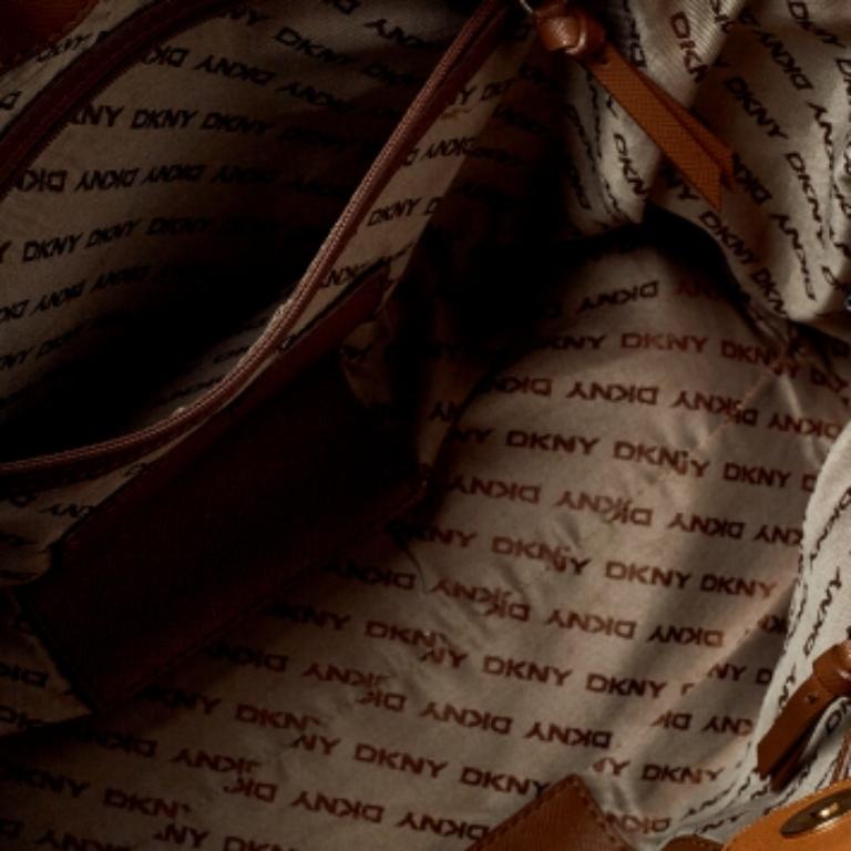 Crafted from the modern woman, the DKNY tote is ideal for a city girl who commutes daily, loves shopping, and travels often. Made from signature canvas, the creation is highlighted with gold-tone hardware and dual handles. The spacious interior is