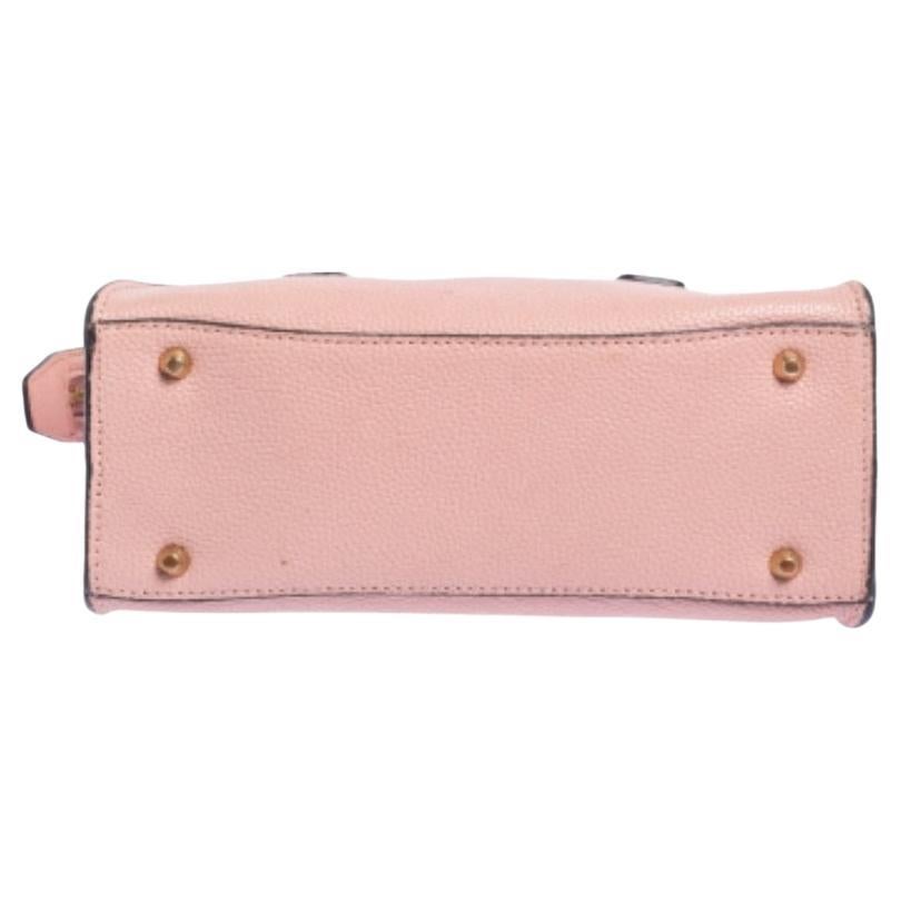 This Chelsea satchel from DKNY offers style and sheer practicality. It's a versatile piece, crafted with leather, it comes in a subtle shade of pink. It features dual handles, a detachable shoulder strap, a nylon interior, and gold-tone hardware.