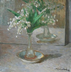 A bouquet of lilies of the valley and a mirror