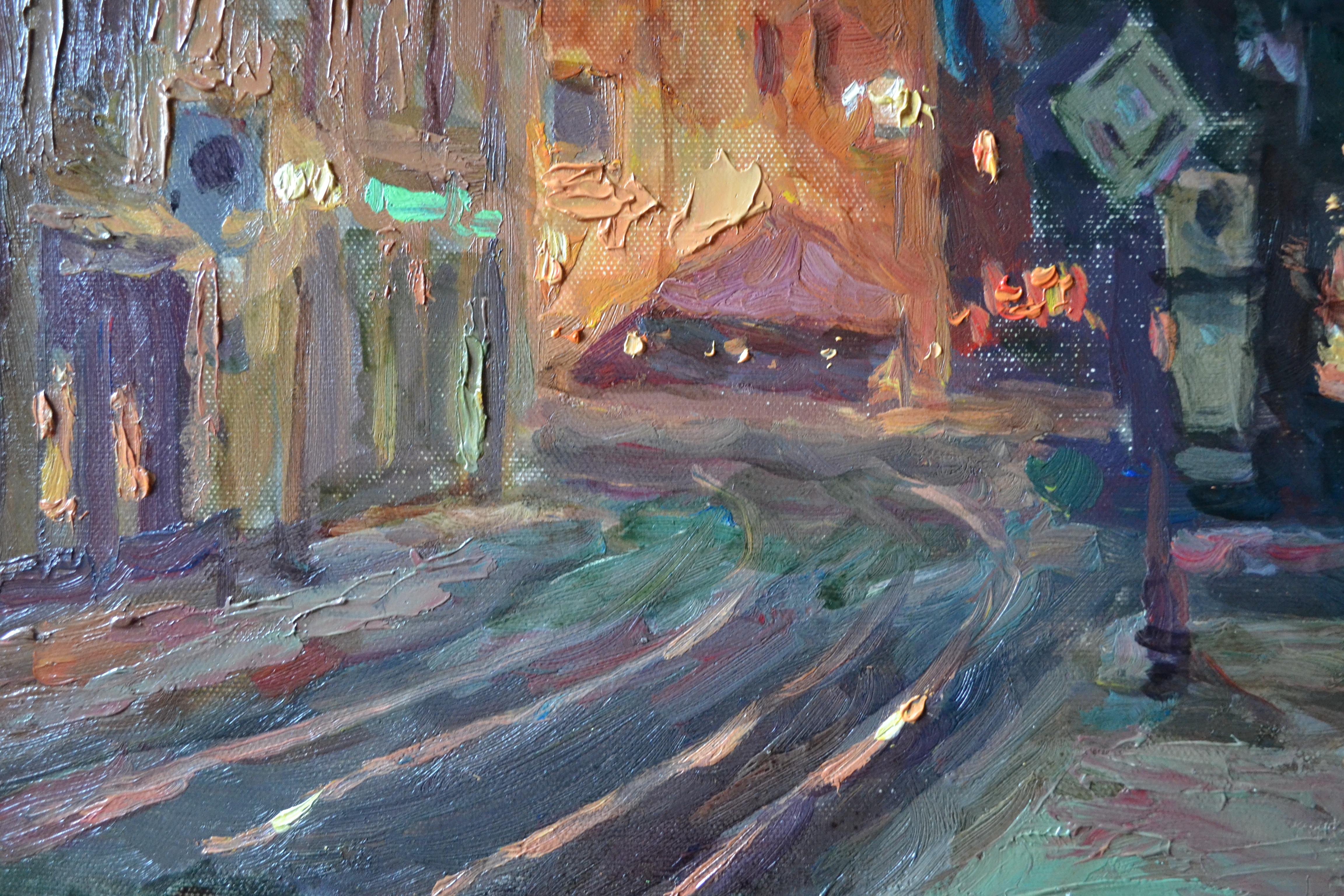 This painting depicts an ancient Bavarian town at night. A blue night sky dominates the entire scene. The deserted town is illuminated by lanterns. The few windows and display cases on the ground floors are lit. The clock face of the medieval town