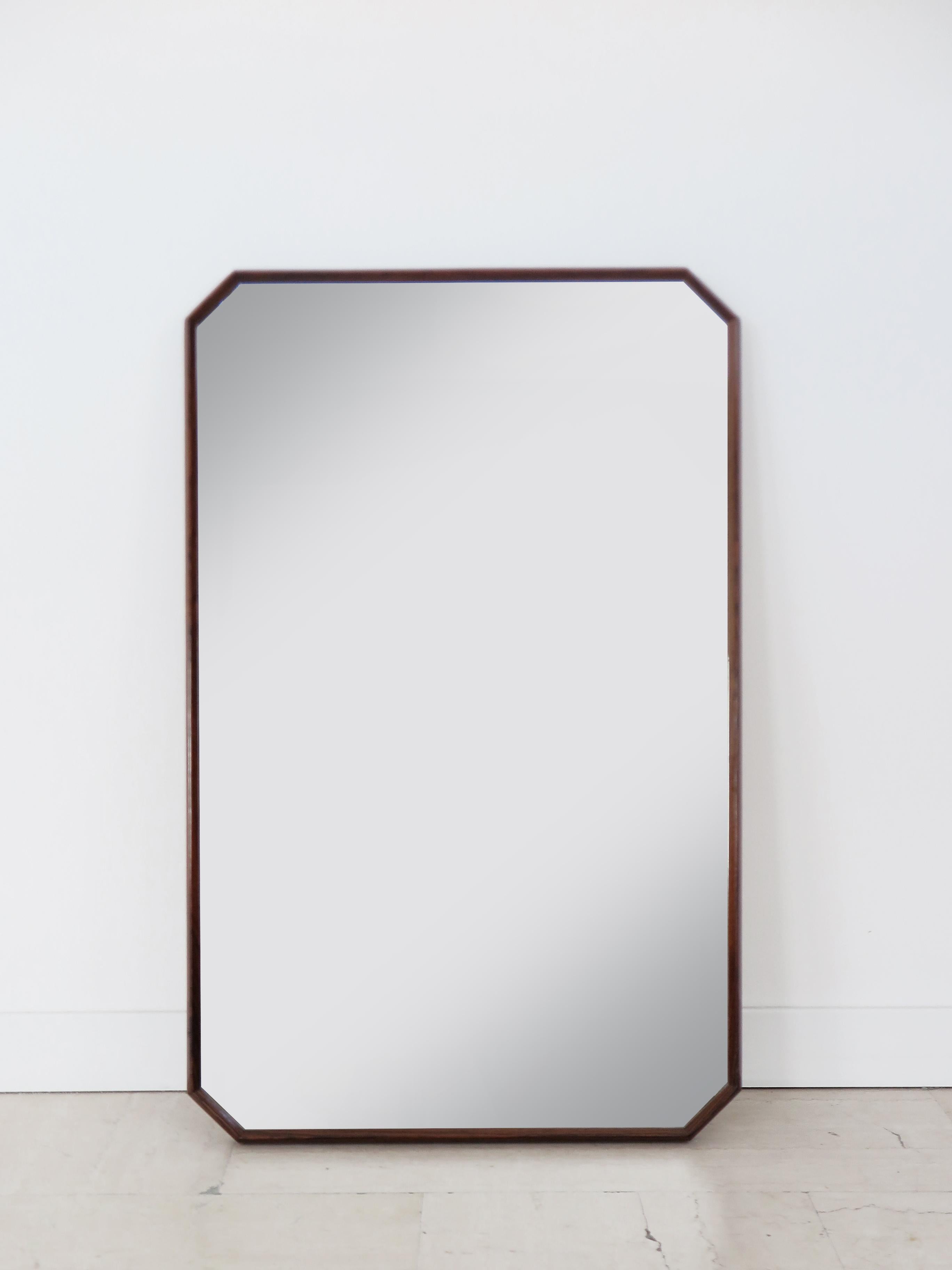 Italian midcentury modern design octagonal wall mirror designed by Dino Cavalli and produced by Tredici with finely worked solid wood frame and mirrored crystal, producytion Italy 1960s