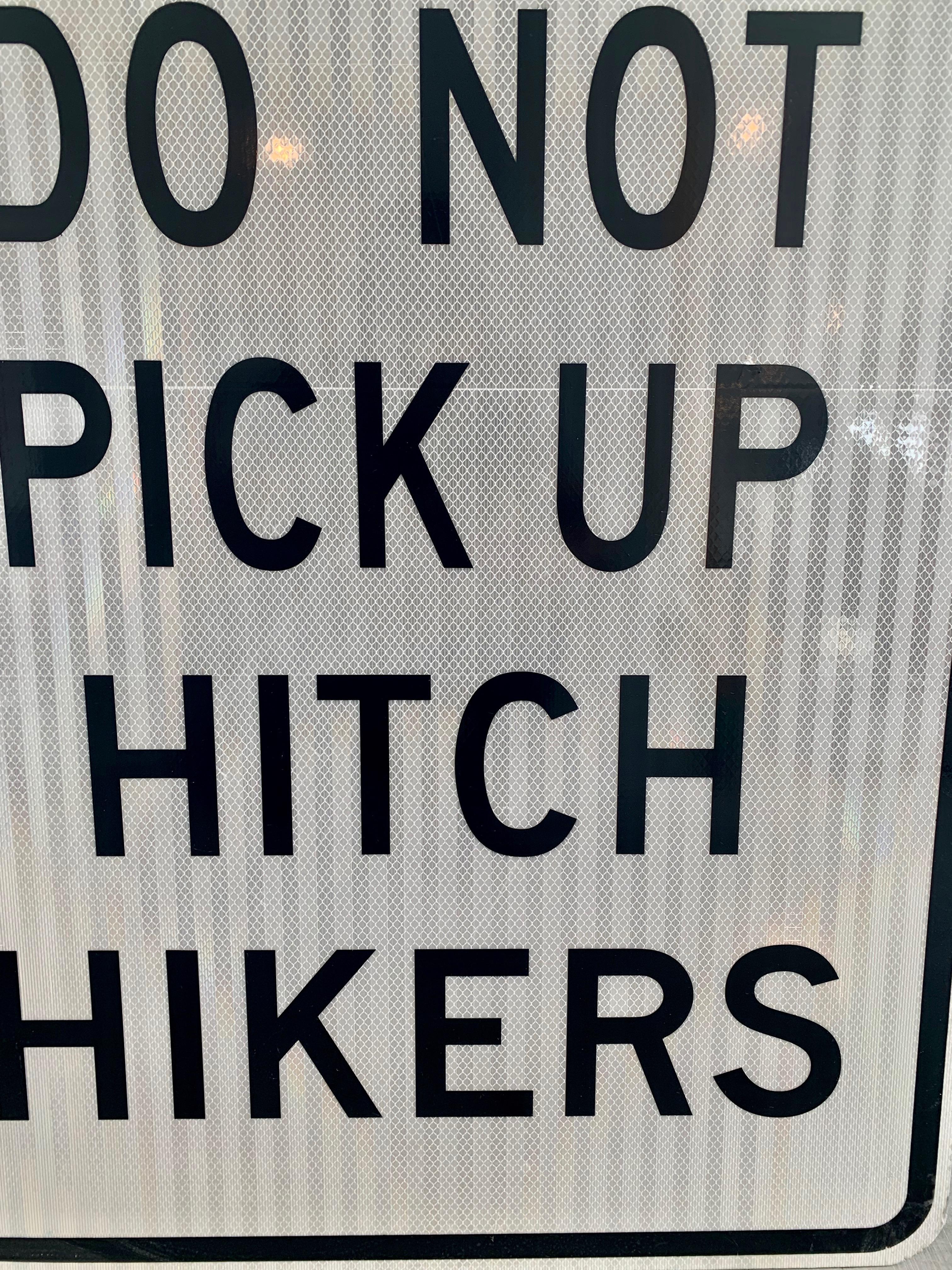 don't pick up hitchhikers sign