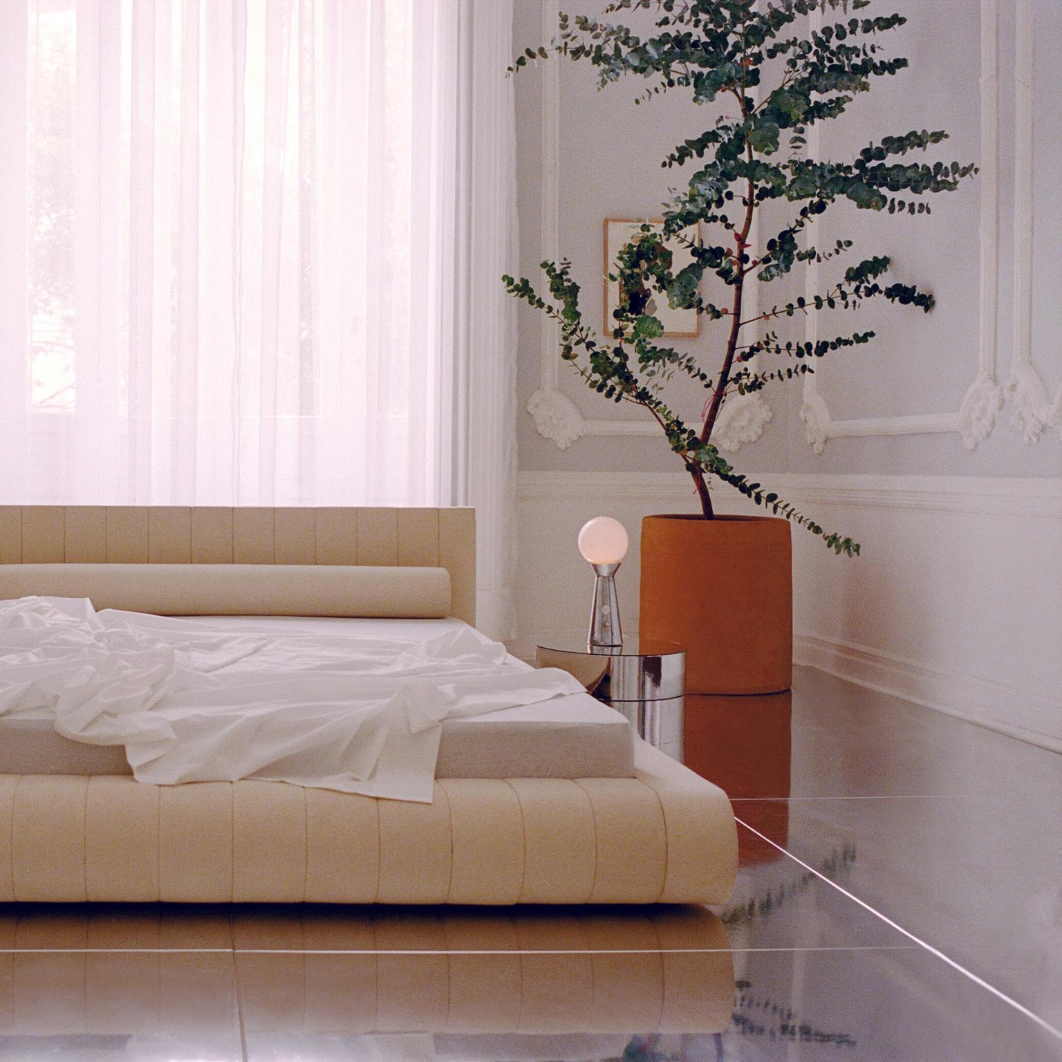 Docked En Rio has a fully upholstered bed frame. The cotton weave is stretched around a folded mattress frame inspired by traditional Japanese furniture. The form is composed of modular cross-sections with a walnut rail that accentuates the folding
