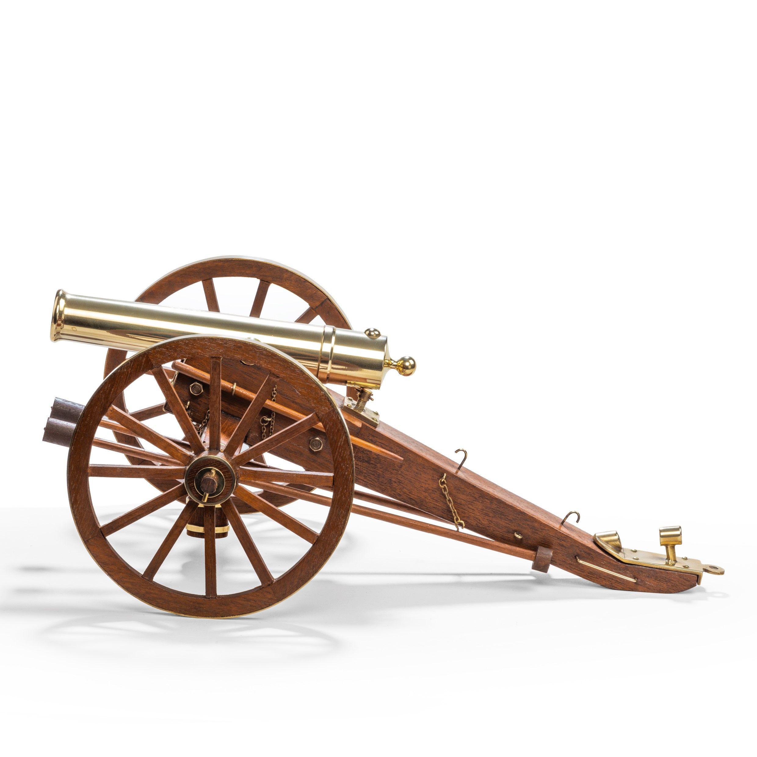 A model of a Dockyard built teak and brass field cannon, with a brass barrel set on a brass-bound carriage with large wheels and a brass-bound bucket, swabs and ramrods to scale, fine quality. English, circa 1930.
 