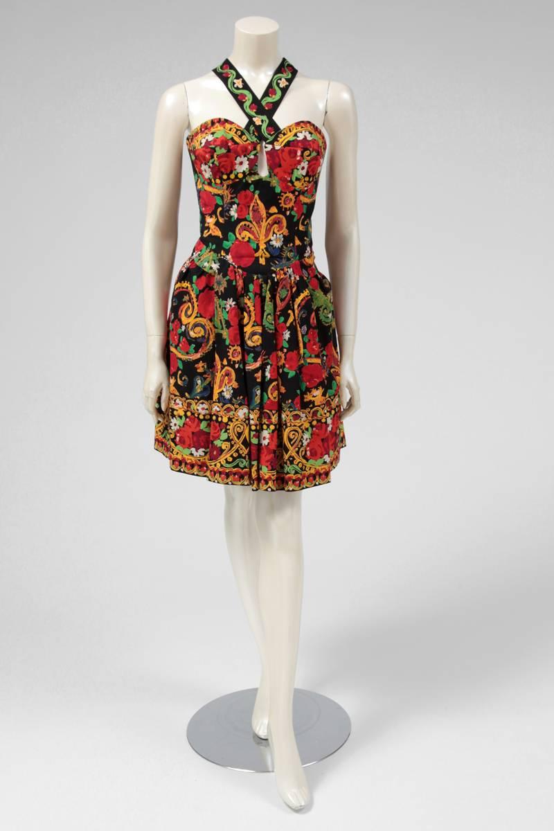 Amazing documented (see picture 7) print cotton dress by Christian Lacroix. With an exuberant and colorful vibrant print, the dress has also a black tulle petticoat which provides more volume to the skirt. The back of the dress has oversized corset