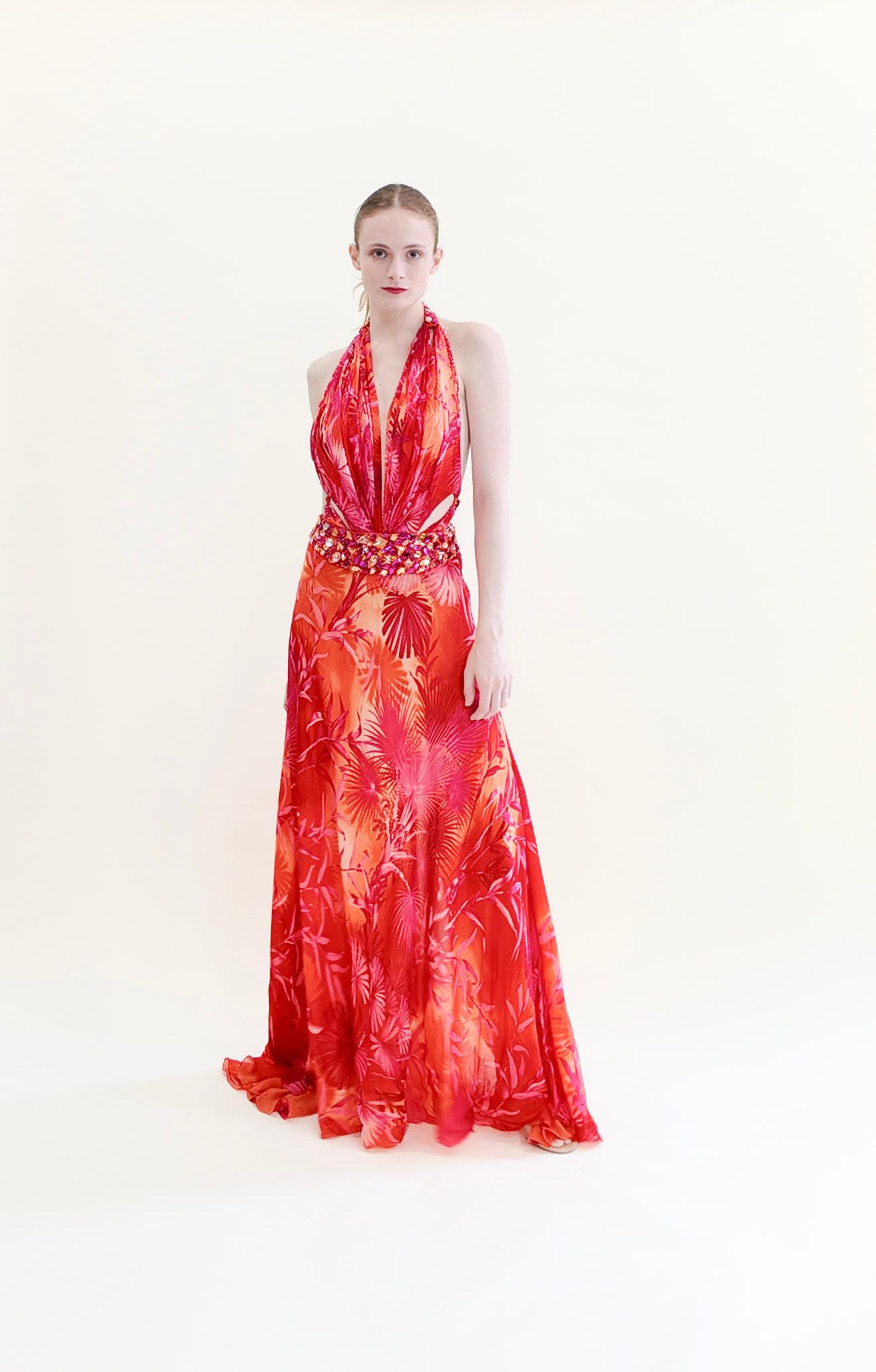 The print on this Gianni Versace S/S 2000 Runway Finale Gown was seen on J.Lo in 2000, and is a must-have for fashion lovers. Featuring a flattering halter neck, jeweled waistline, and open back detail, and a high back split -  this vibrant palm