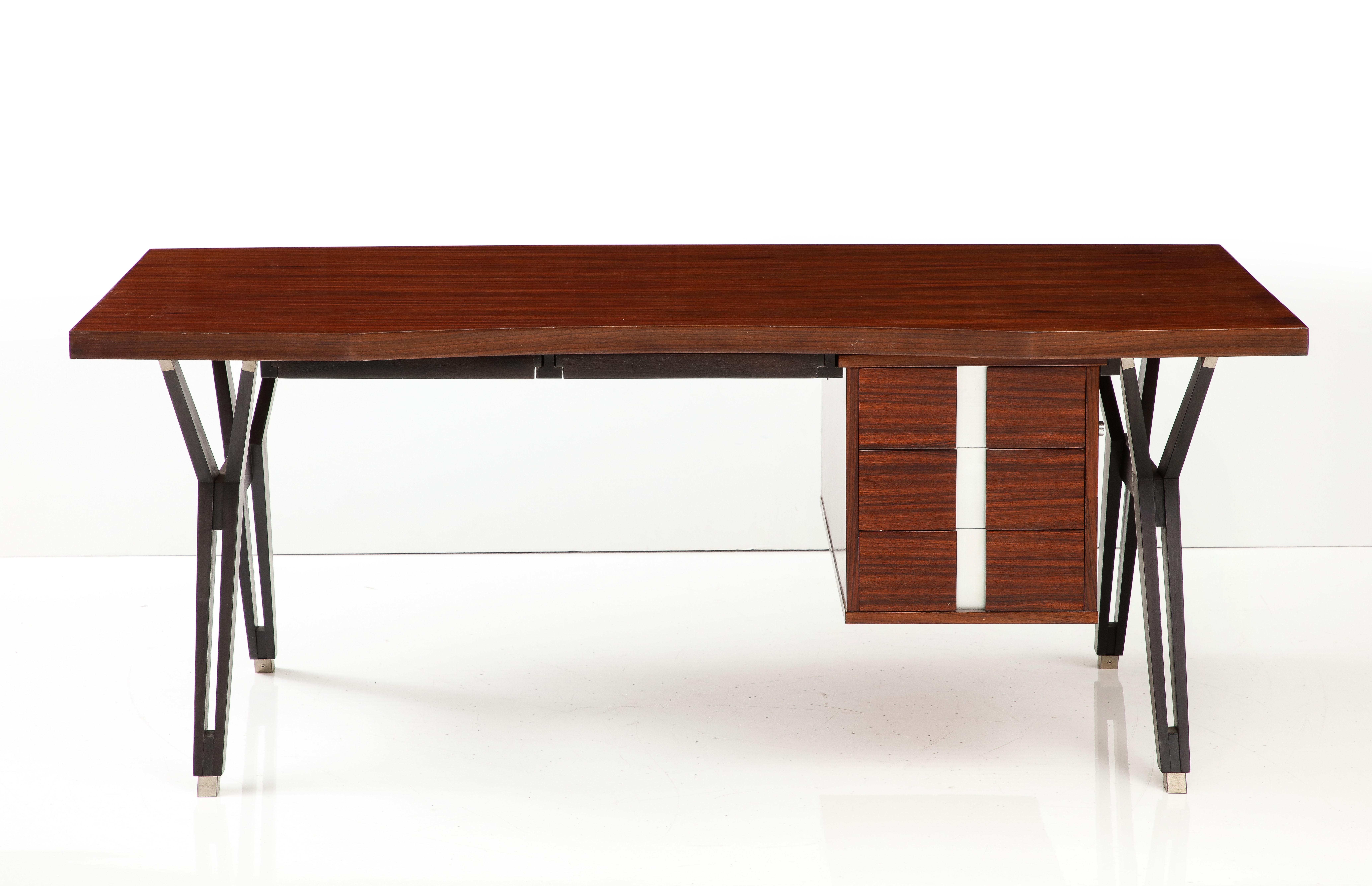 This iconic Mid-Century Modern executive desk was the result of a collaboration between the masterful Italian architect and designer, Ico Parisi and his wife, Luisa, a student of Gio Ponti. The 