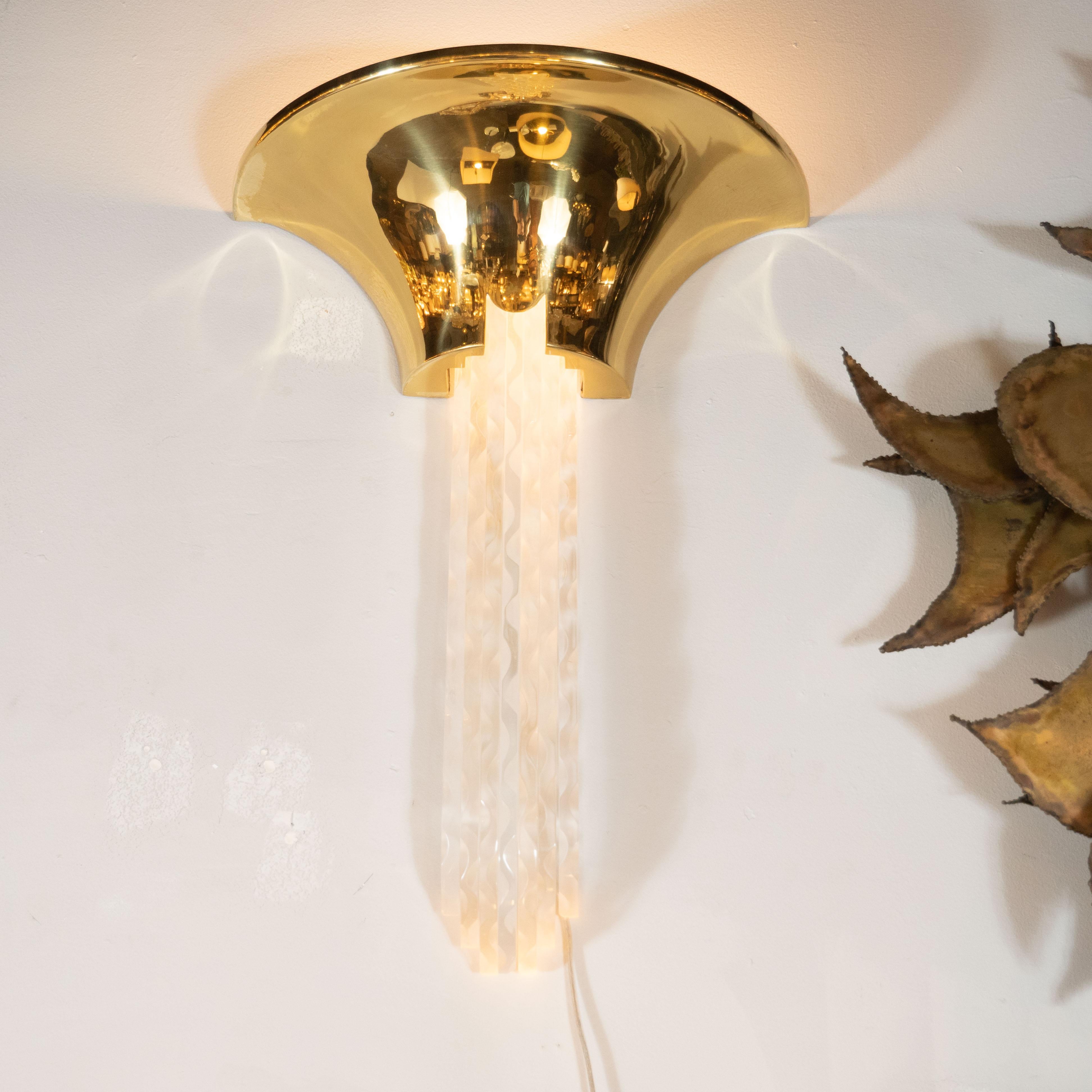 These iconic and dramatic sconces were designed by Karl Springer- one of the most important and influential designers of the 20th century- in America circa 1970. They feature demilune tops with bowed sides. Streamlined and illuminated Lucite