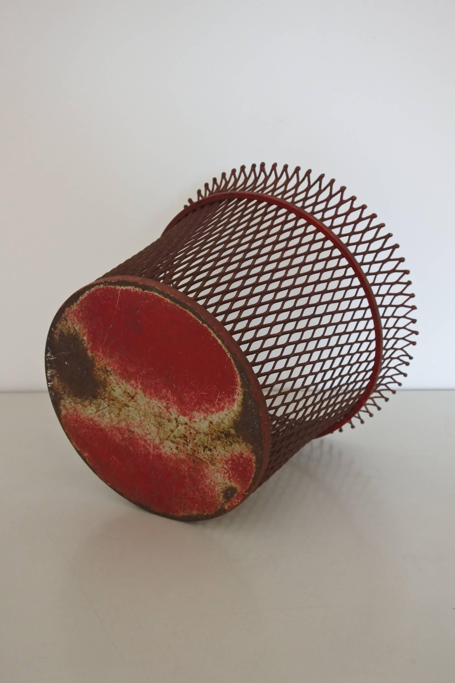 Midcentury wastepaper basket by French designer Mathieu Mategot. 
Red lacquered metal. Original lacquer.
It is documented in the book 