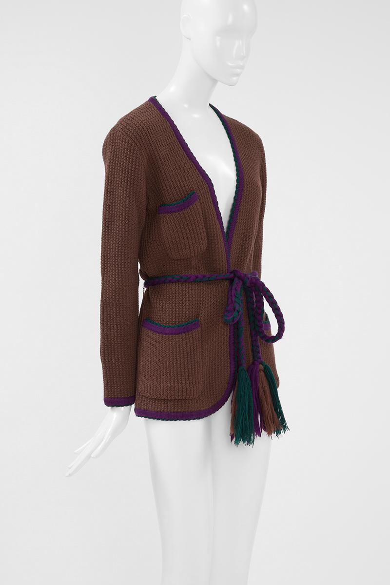 YSL has always excelled at creating practical garments that would never go out of style. This early 70's cardigan is an example. Made in France, it is rib-knitted from wool and has scalloped edges outlined in a deep duck green thread. Associated to
