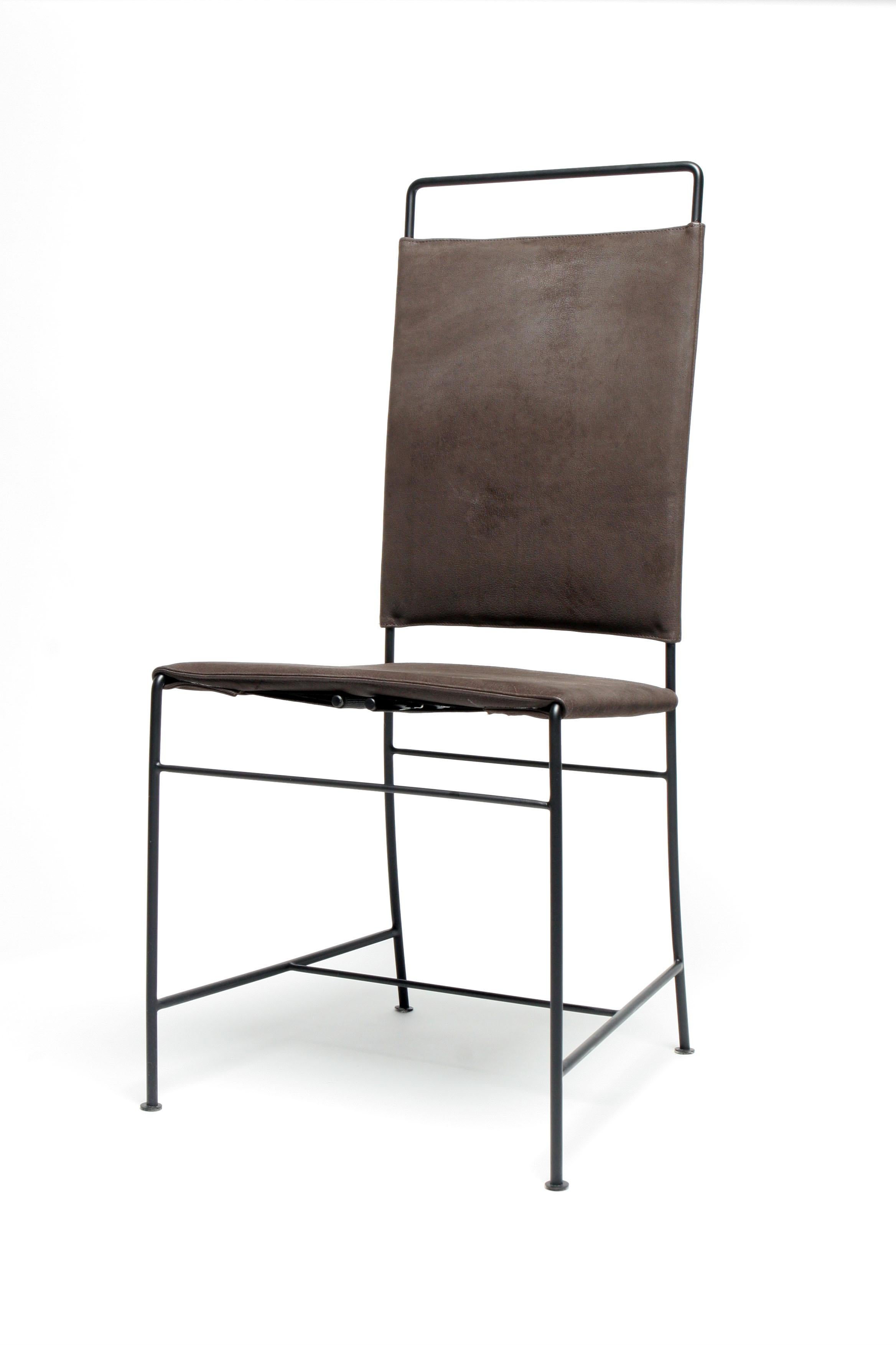 The Dodi chair has a blackened steel frame with a tight wrapped leather seat and back in Espresso Buffalo Leather. Cross stretchers offer stability and the legs are finished with coin-shaped tabs.

The chair frame is also available in stainless